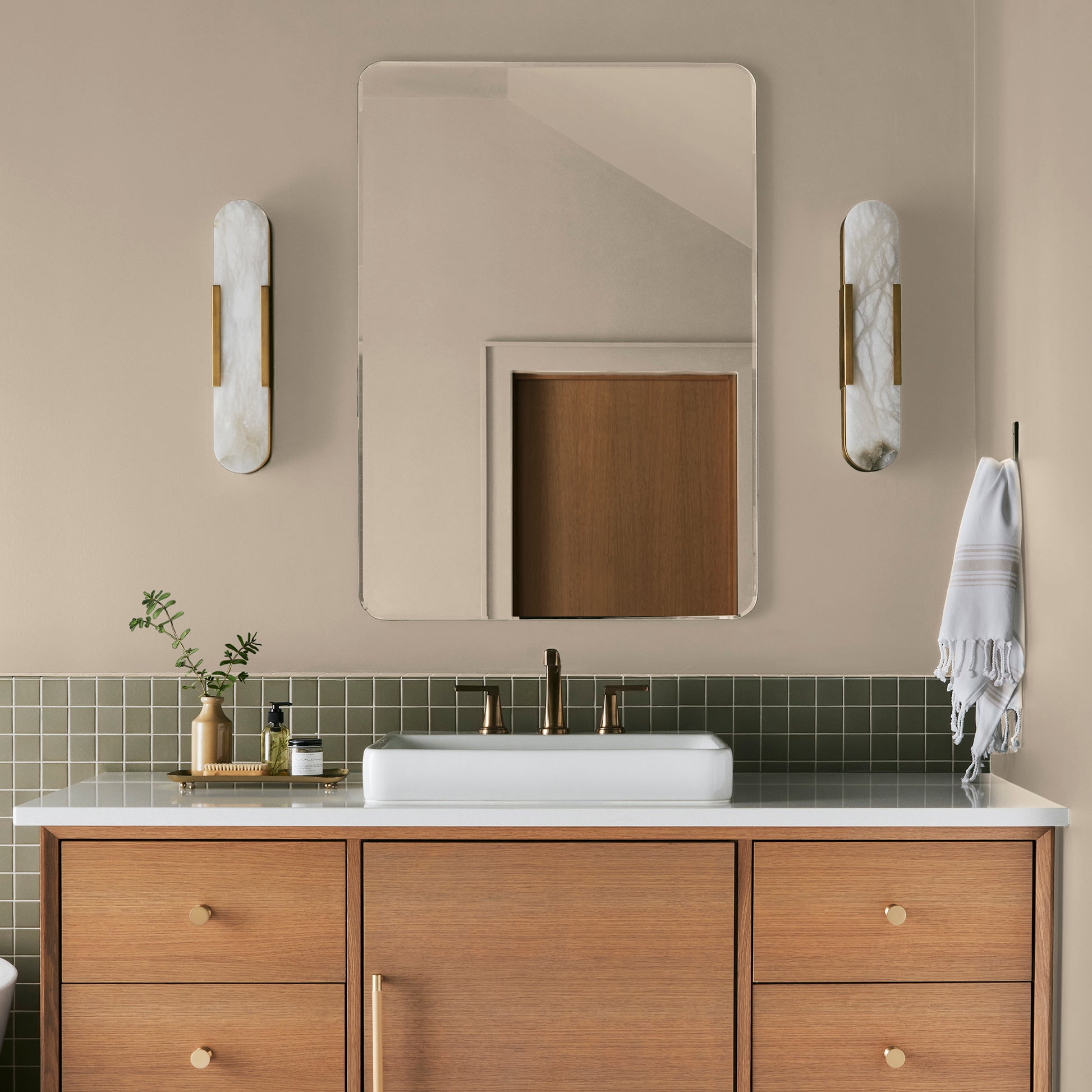 light tan with a yellow undertone paint named soft landing shown painted on bathroom wall