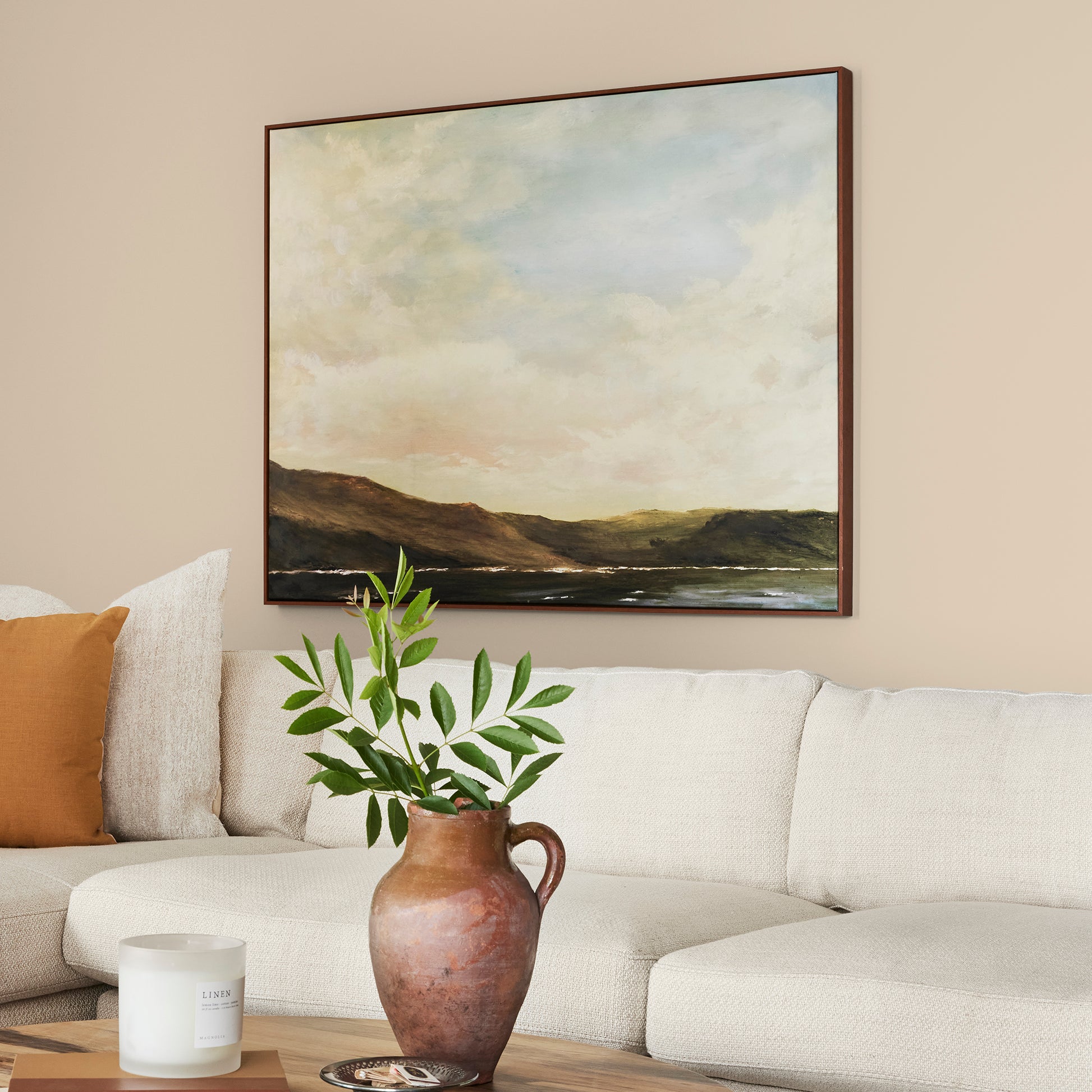 light tan with a yellow undertone paint named soft landing shown painted on living room wall