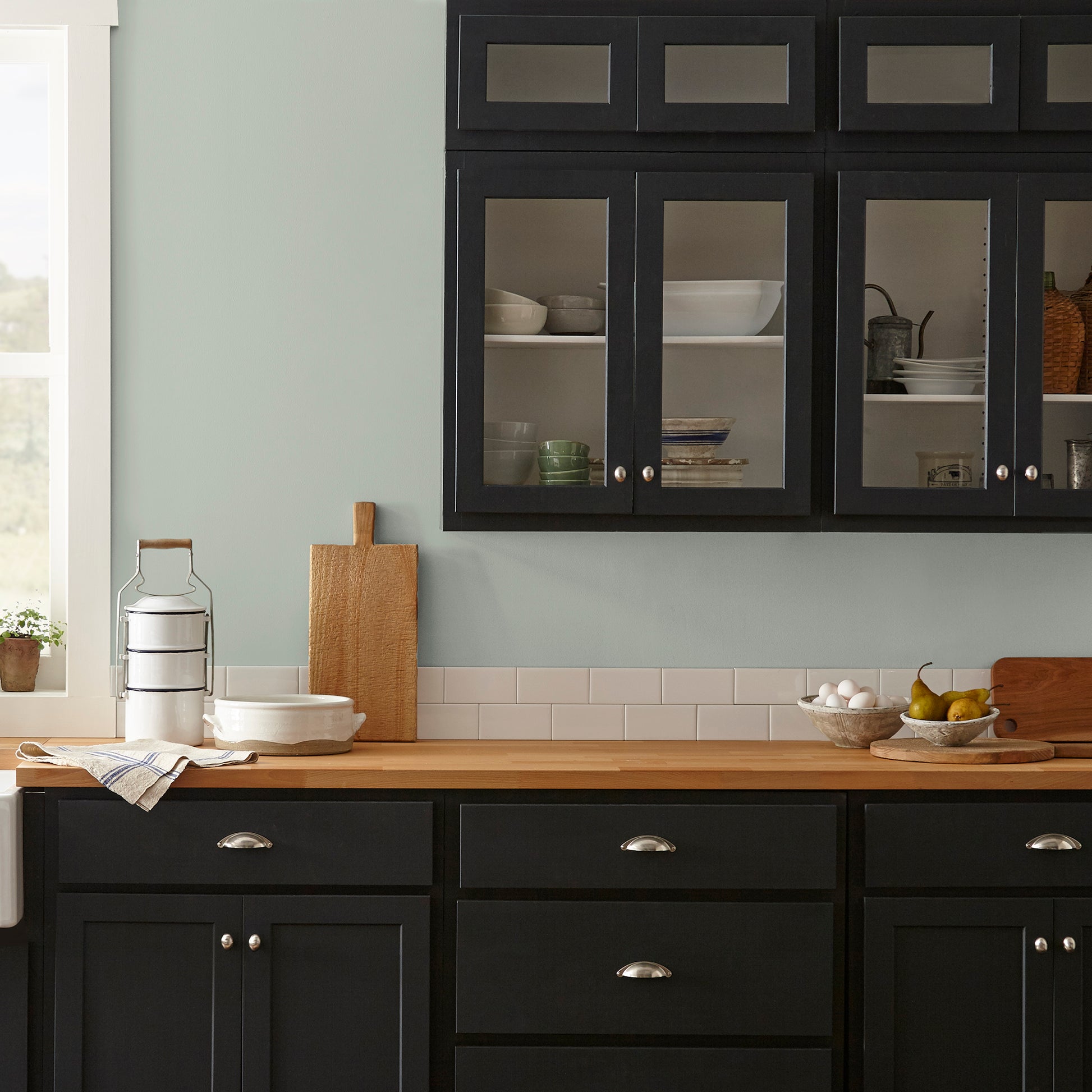 medium grey with cool green blue undertones paint name americana egg shown painted on kitchen wall
