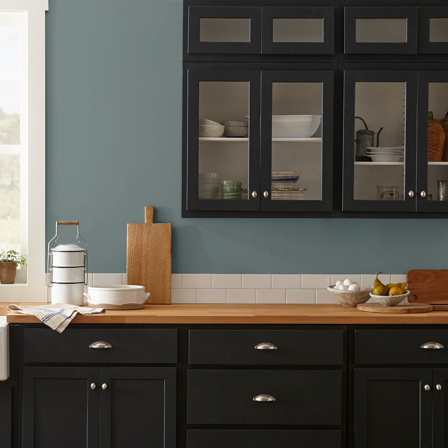 deep muted blue with grey undertones paint named duke gray shown painted on kitchen wall