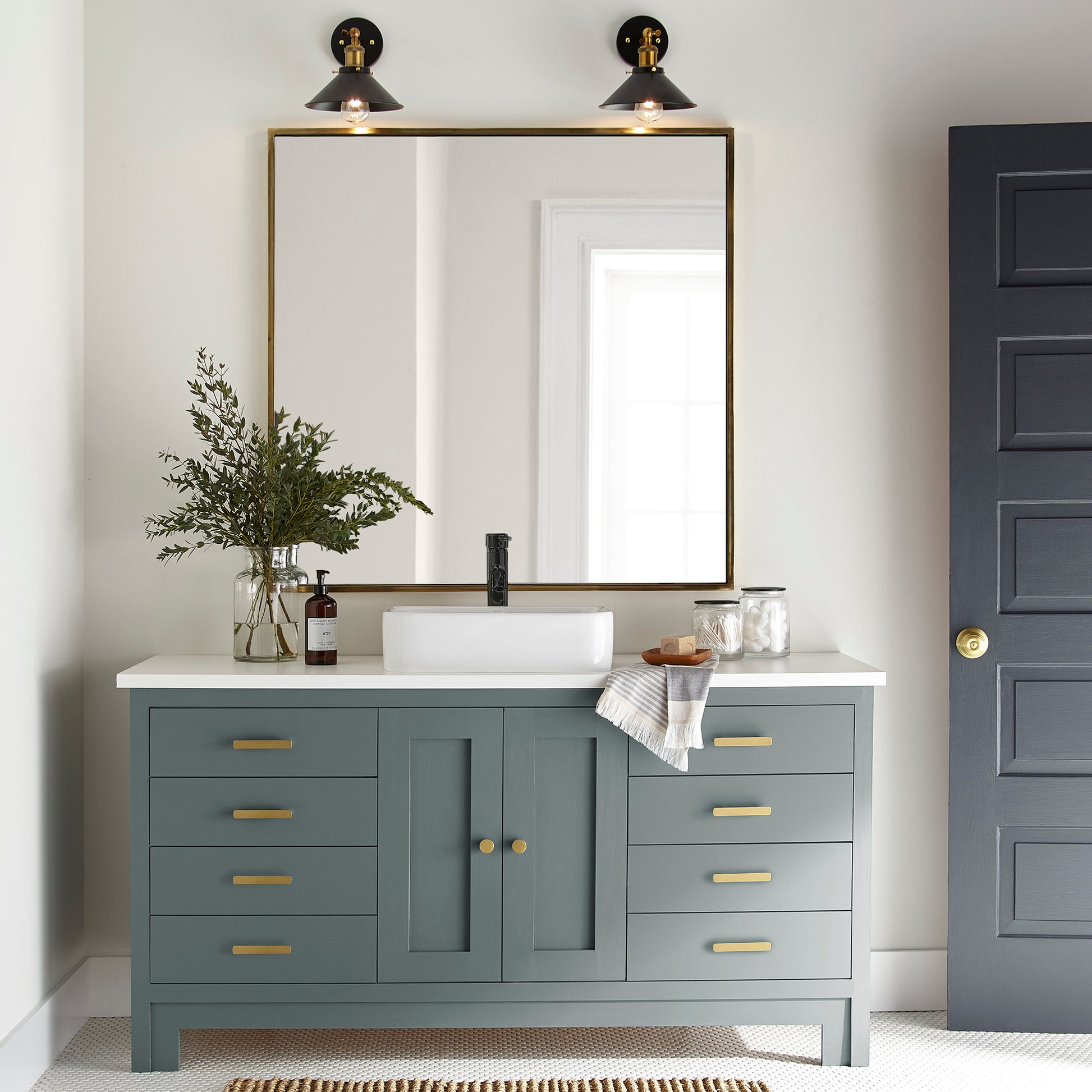 deep muted blue with grey undertones door and cabinet paint named duke gray shown painted on bathroom cabinet