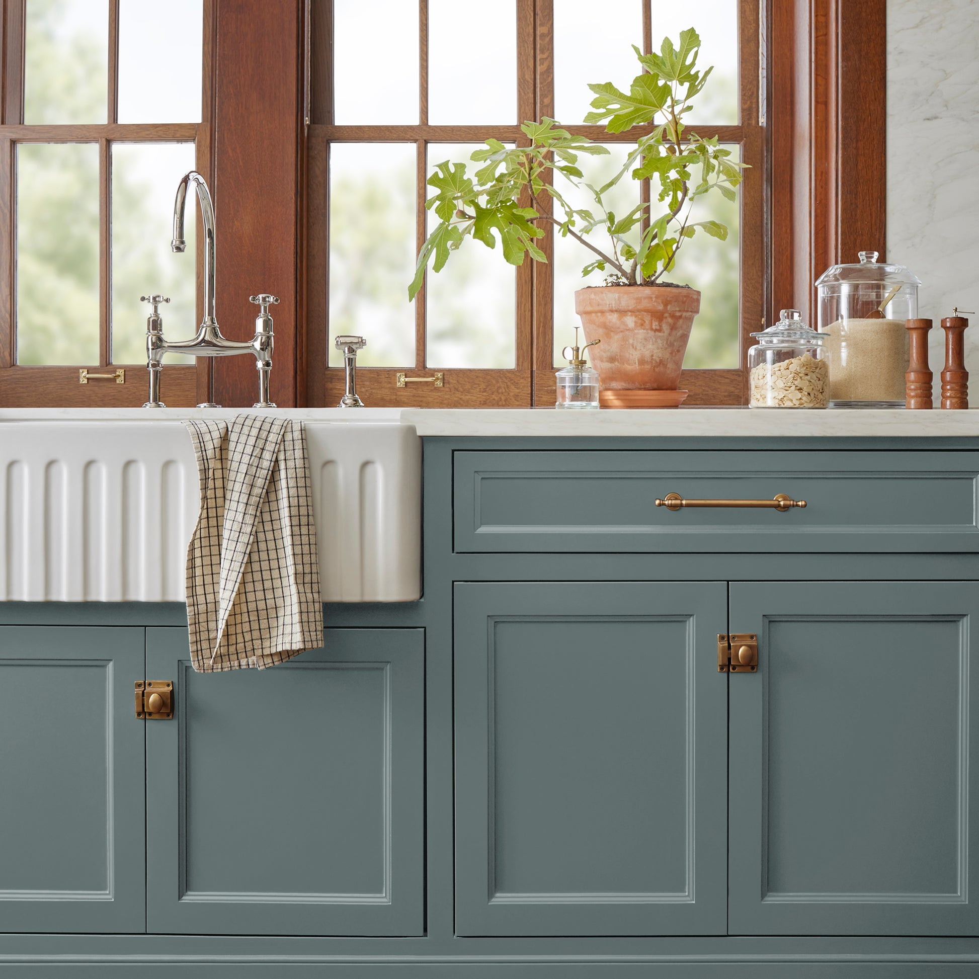 deep muted blue with grey undertones door and cabinet paint named duke gray shown painted on kitchen cabinet