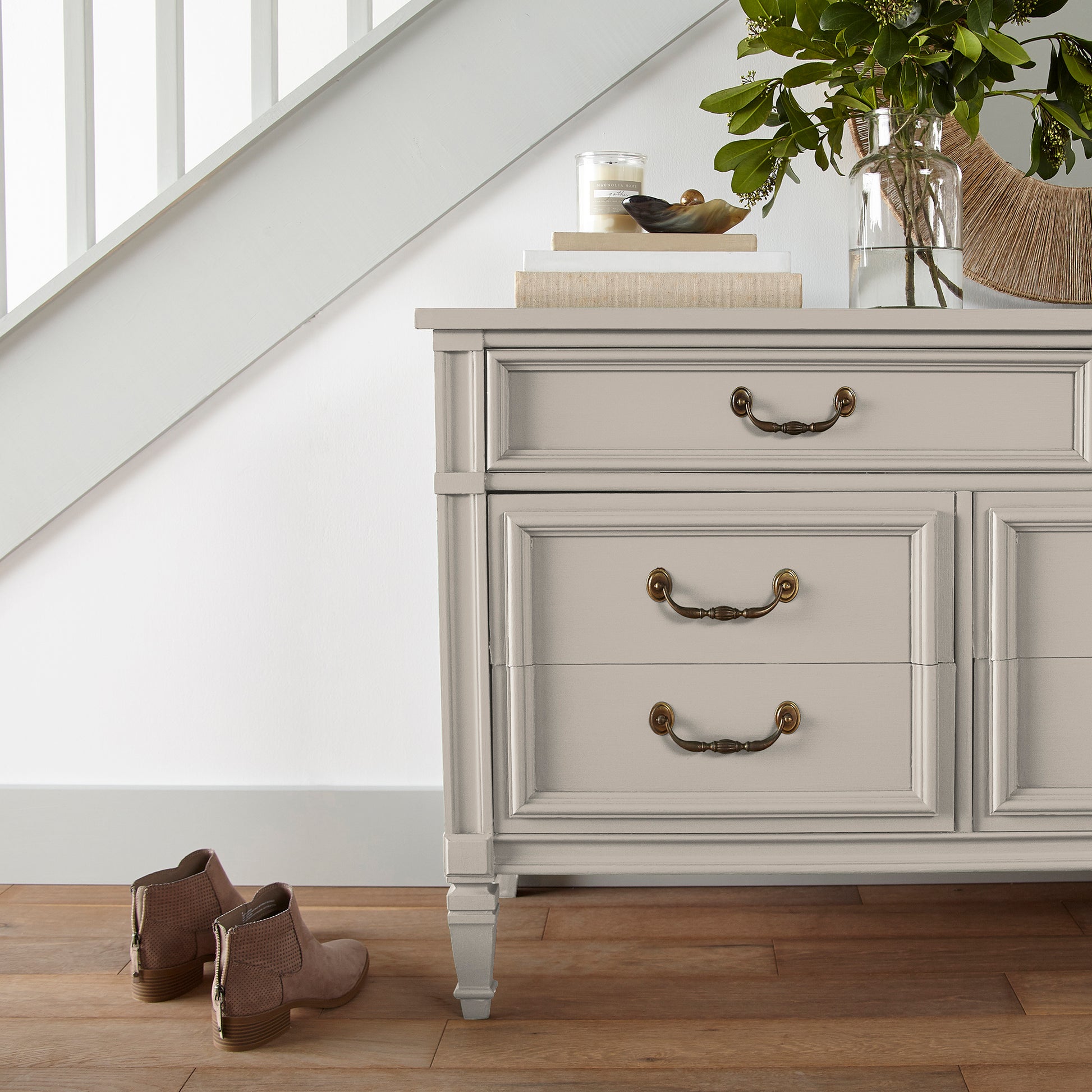 Oatmeal white with peach accents door and cabinet paint named Soft Linen shown painted on entryway cabinet