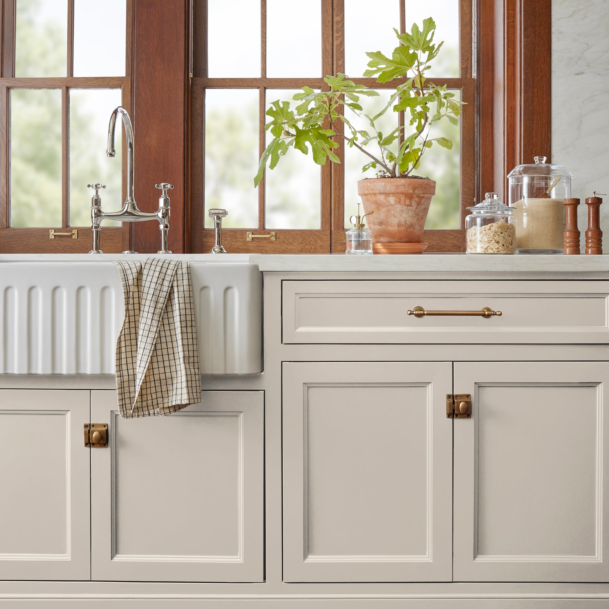 Oatmeal white with peach accents door and cabinet paint named Soft Linen shown painted on kitchen cabinet