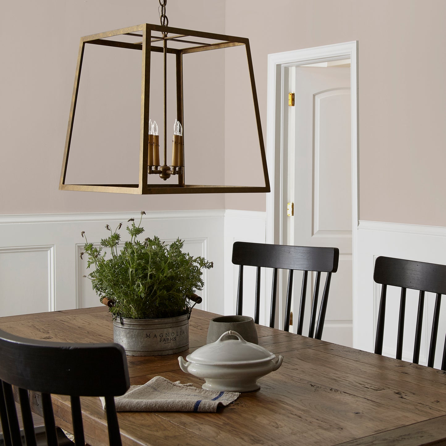 Sandy tan with pink notes interior paint named cinnamon sugar shown painted on dining room wall
