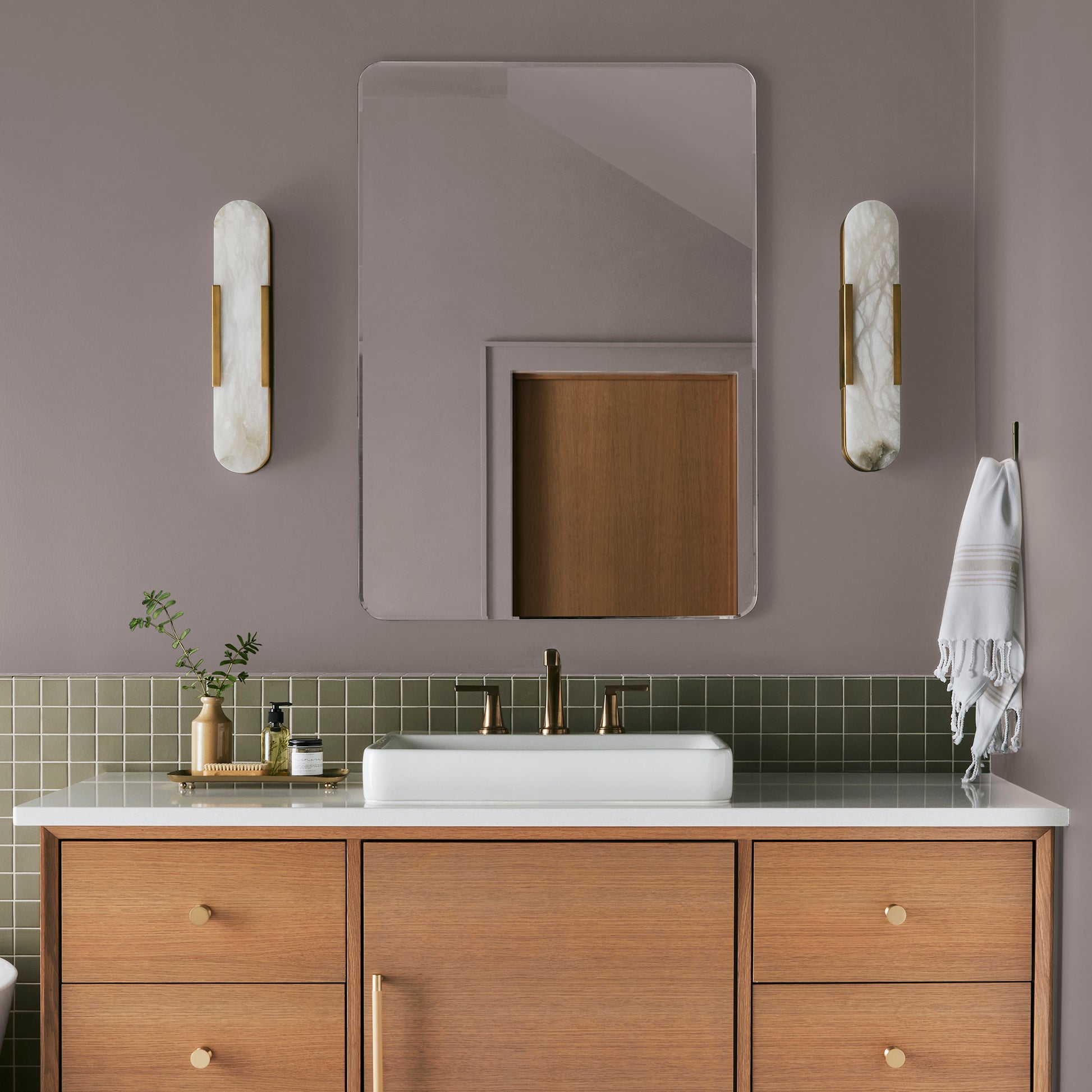 A mid-tone mauve interior paint named homebody shown painted on bathroom wall