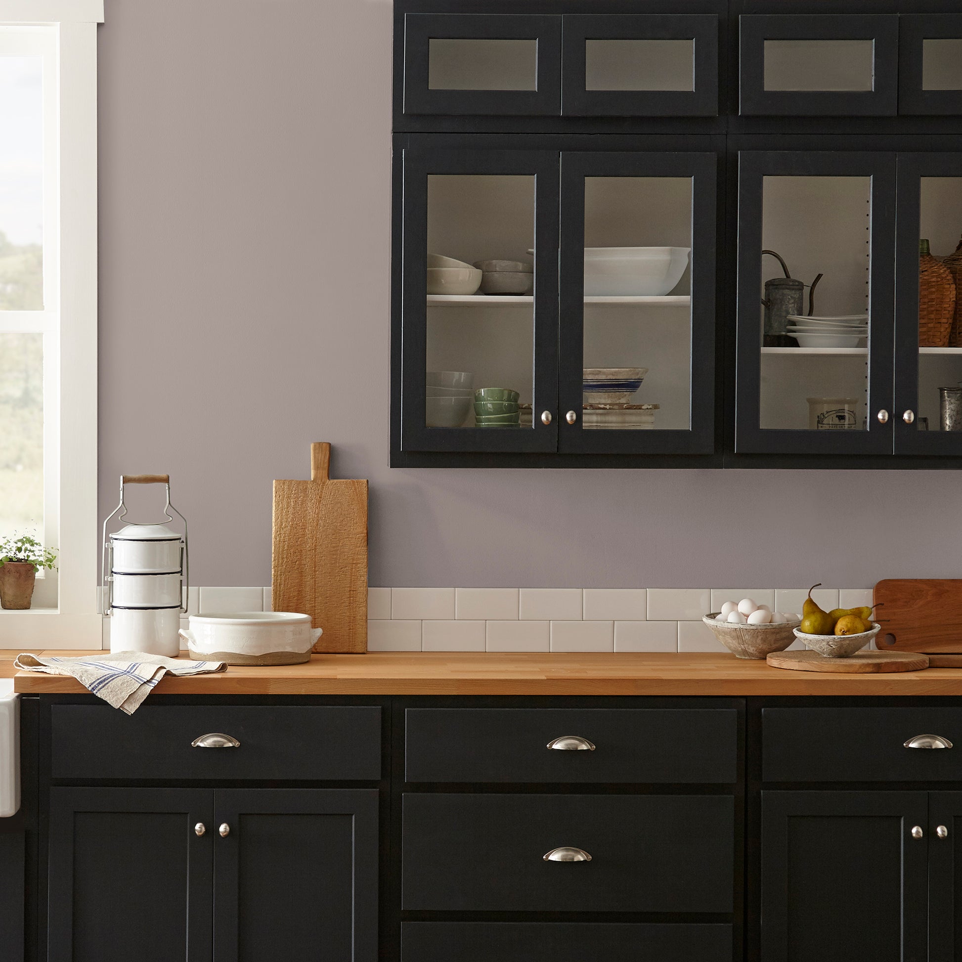 A mid-tone mauve interior paint named homebody shown painted on kitchen wall