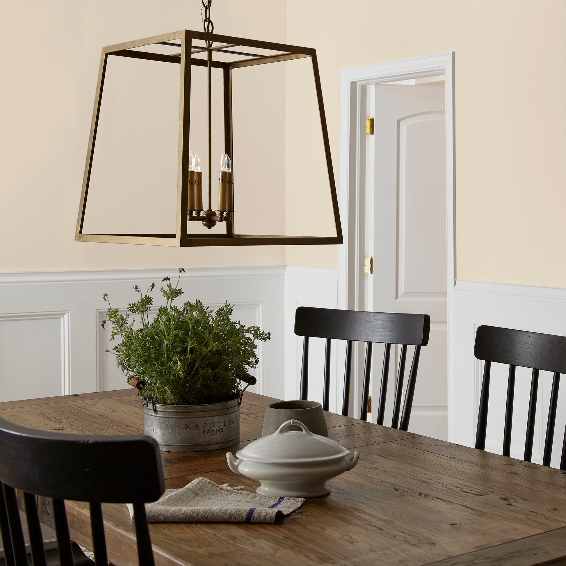Warm white with soft notes of beige and honey interior paint named lit candles shown painted on dining room wall