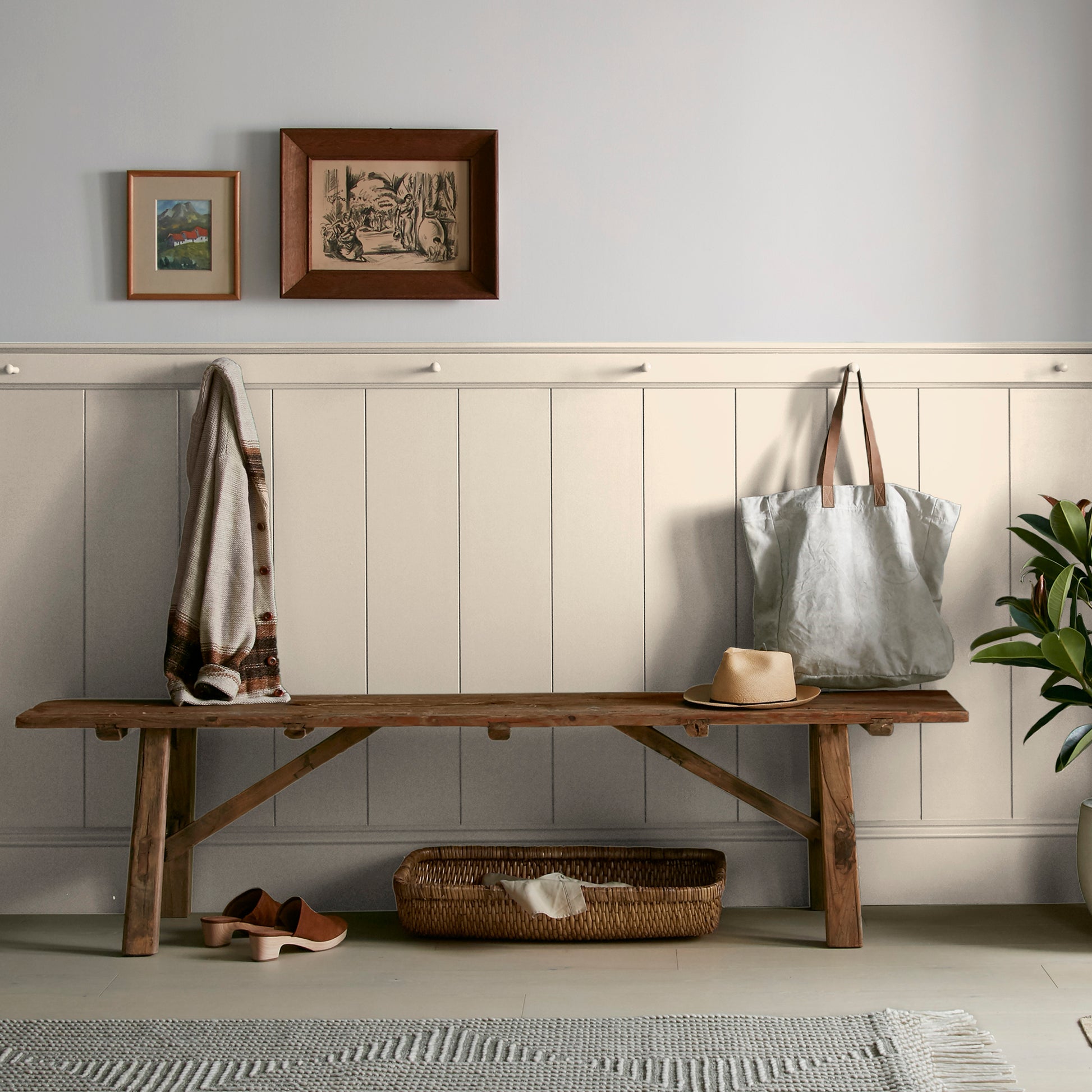 Warm white with soft notes of beige and honey interior paint named lit candles shown painted on entryway wall