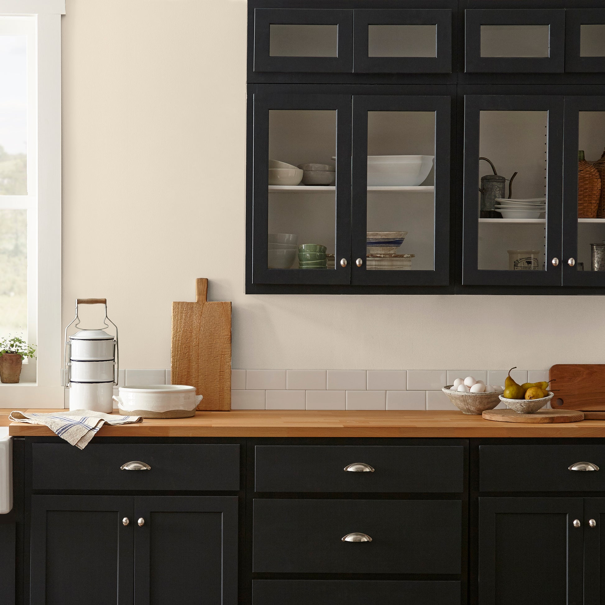 Warm white with soft notes of beige and honey interior paint named lit candles shown painted on kitchen wall