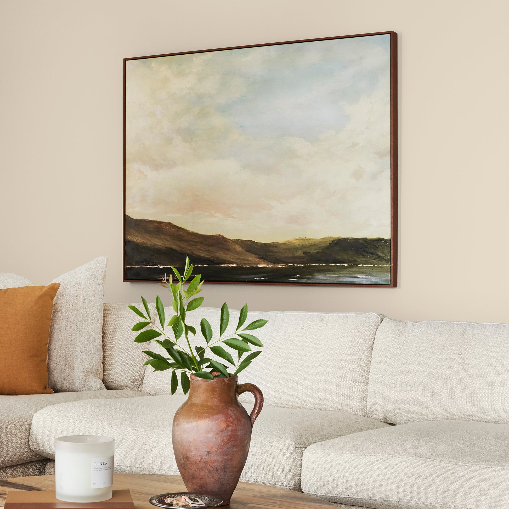 Warm white with soft notes of beige and honey interior paint named lit candles shown painted on living room wall