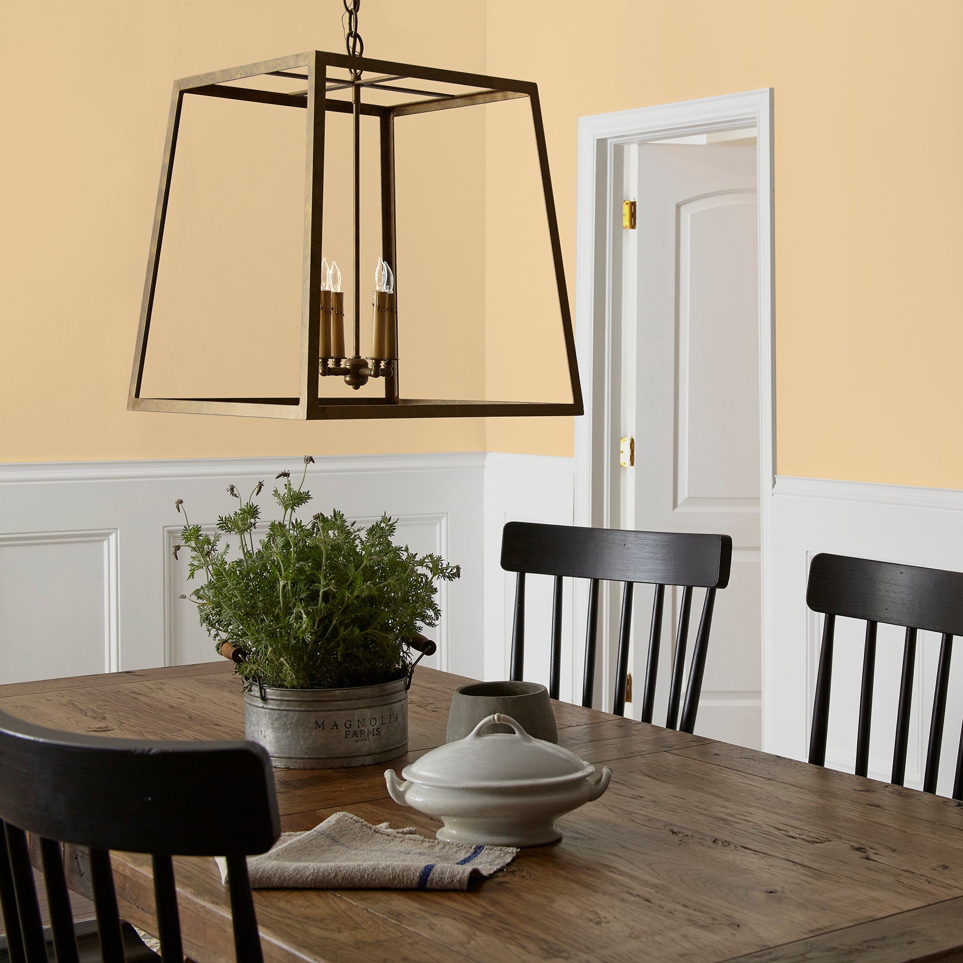 Creamy honey and citrus yellow interior paint named lemony shown painted on dining room wall