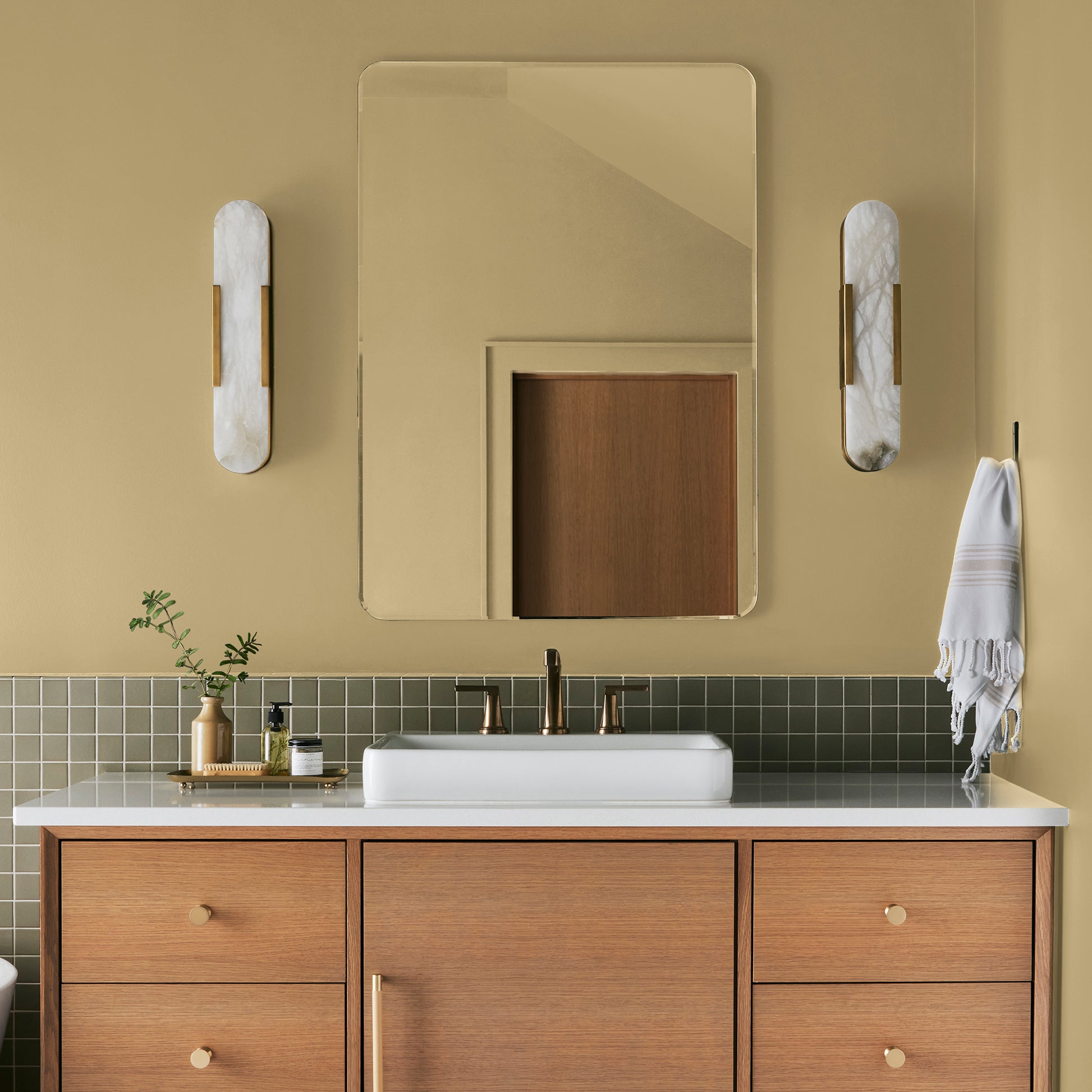 muted yellow with green undertones paint named heirloom yellow shown painted on bathroom wall