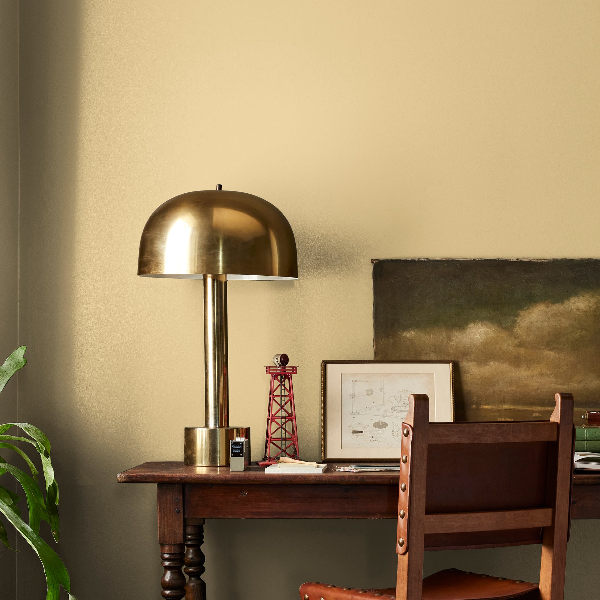 muted yellow with green undertones paint named heirloom yellow shown painted on bedroom wall