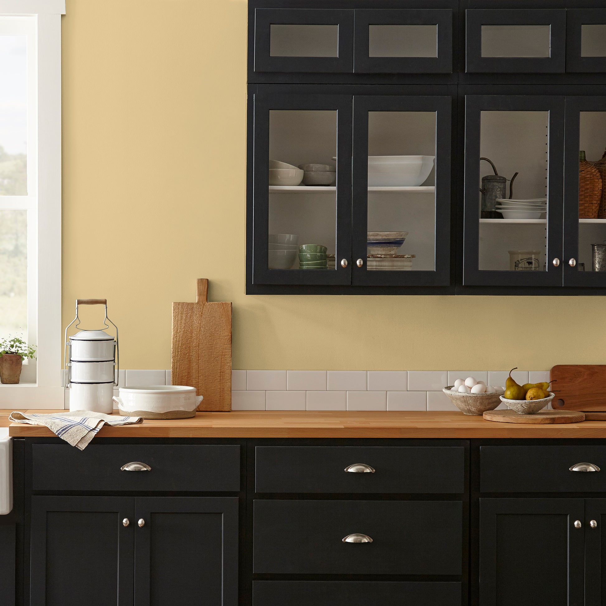 muted yellow with green undertones paint named heirloom yellow shown painted on kitchen wall