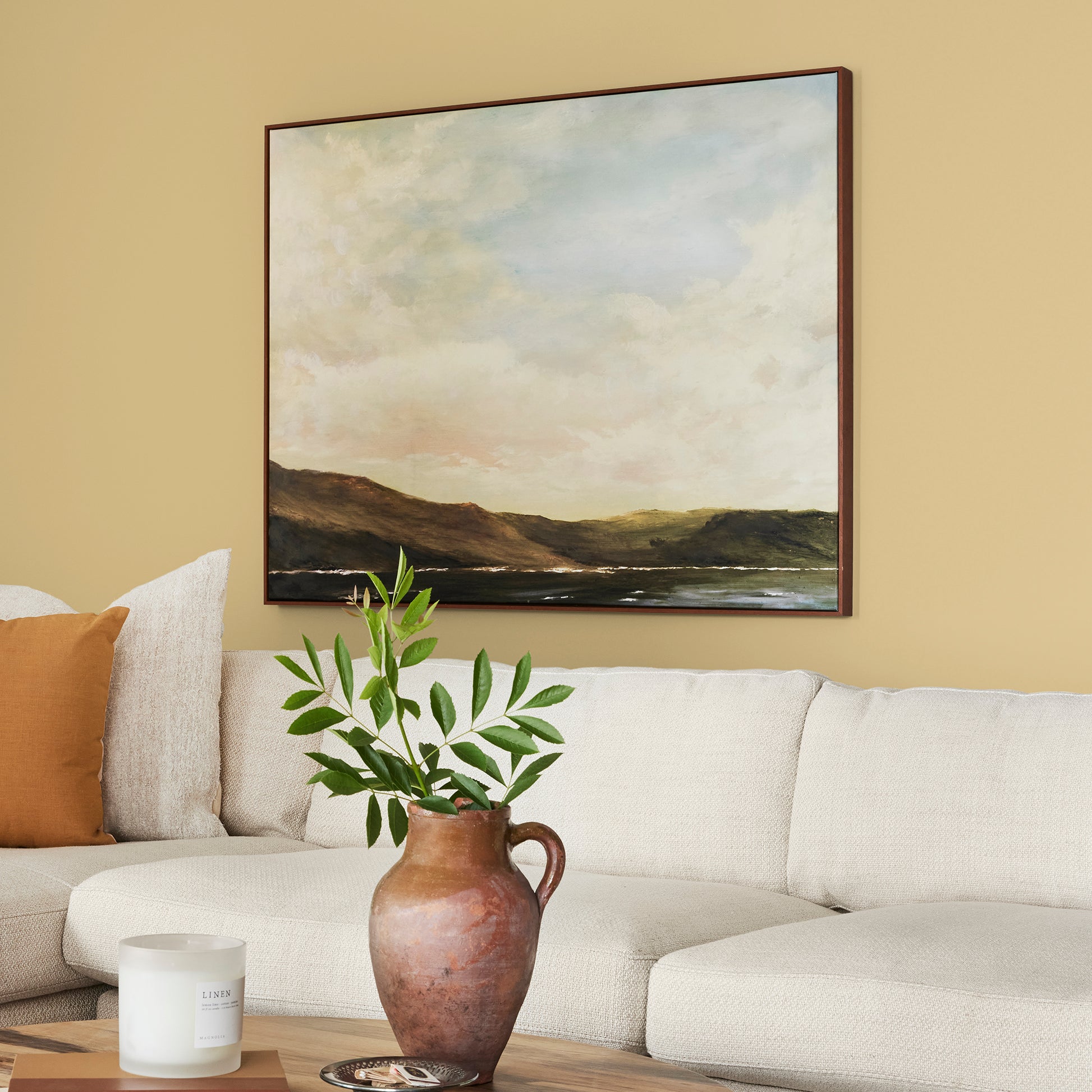 muted yellow with green undertones paint named heirloom yellow shown painted on living room wall