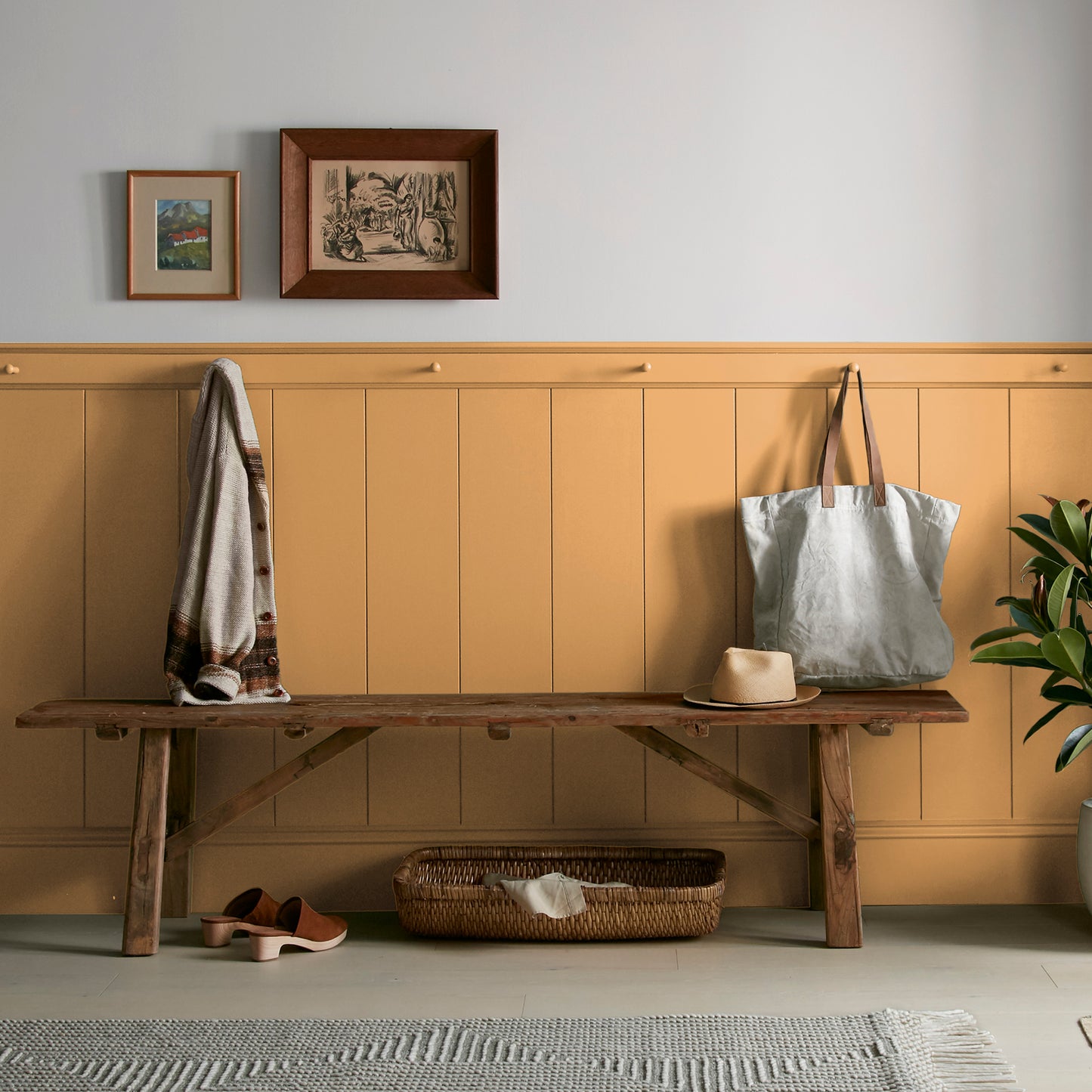 Rich ochre yellow interior paint named brushed clay shown painted on entryway wall