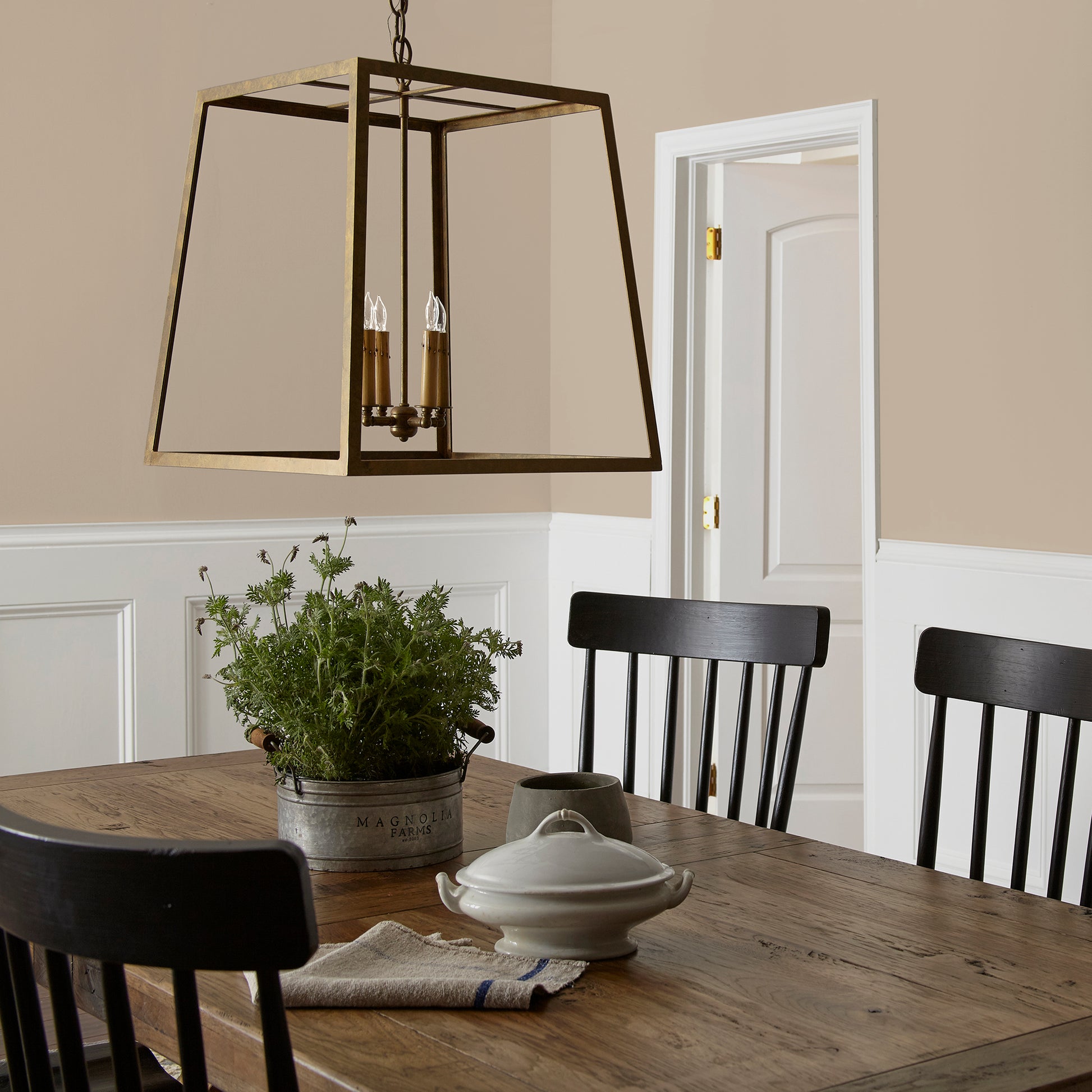 Tan and beige with notes of honey interior paint named embossed letter shown painted on dining room wall