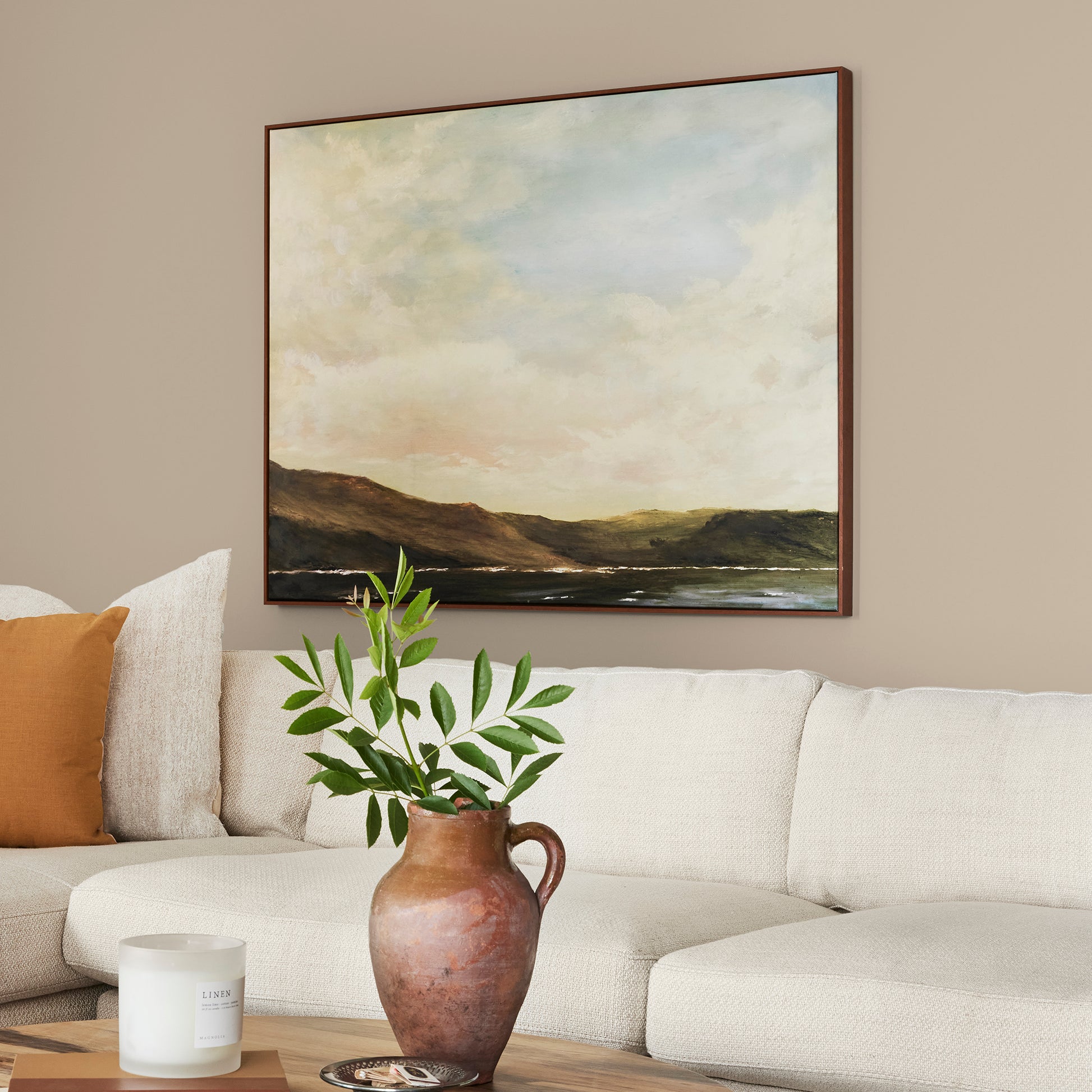Tan and beige with notes of honey interior paint named embossed letter shown painted on living room wall