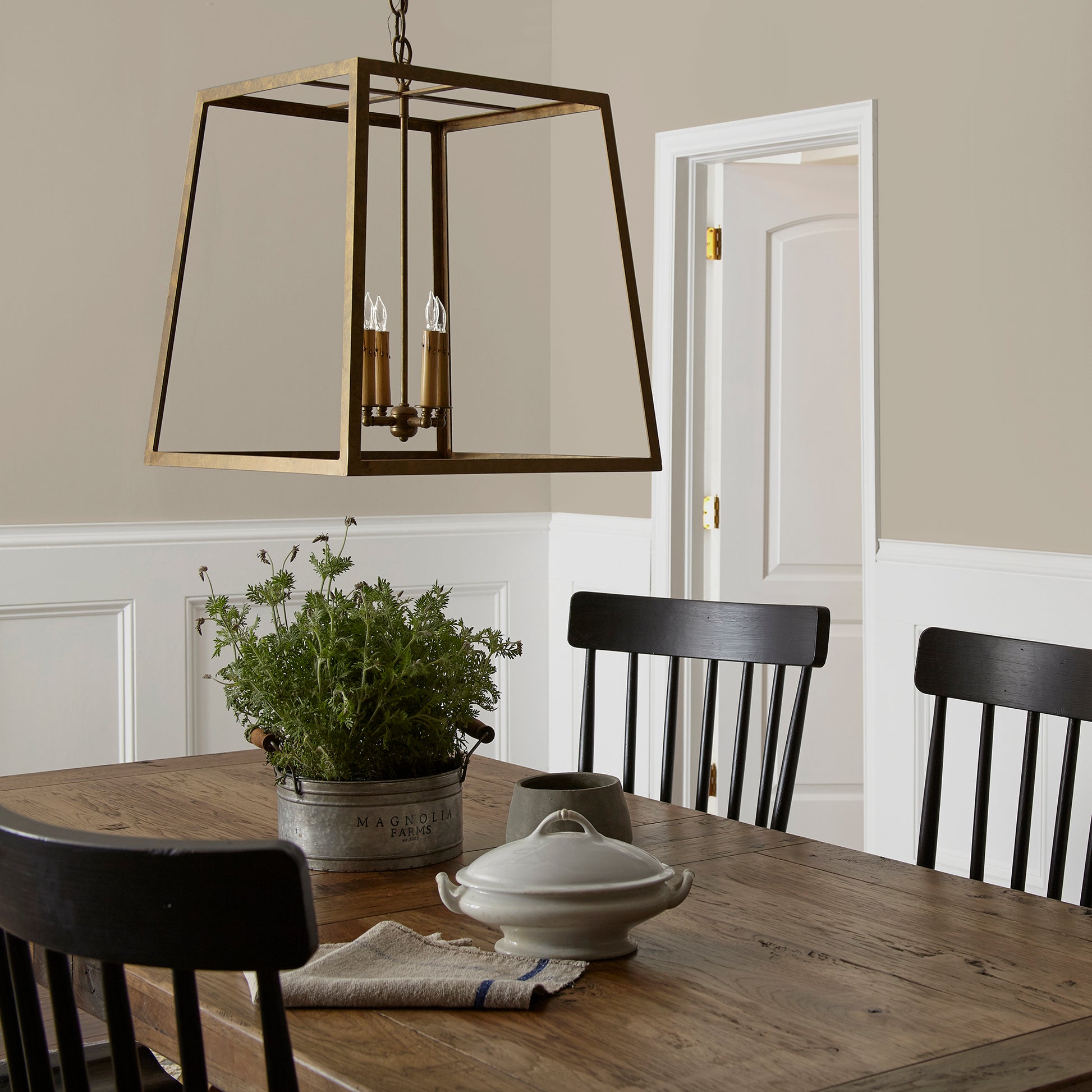 Mid-toned tan with a hint of green interior paint named renewed shown painted on dining room wall