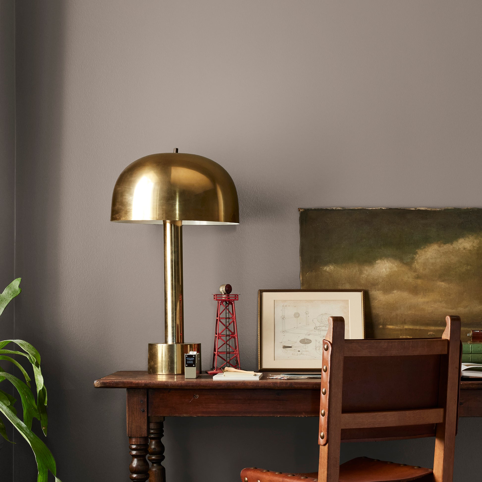 A warm brown with yellow accents interior paint named elemental shown painted on bedroom wall