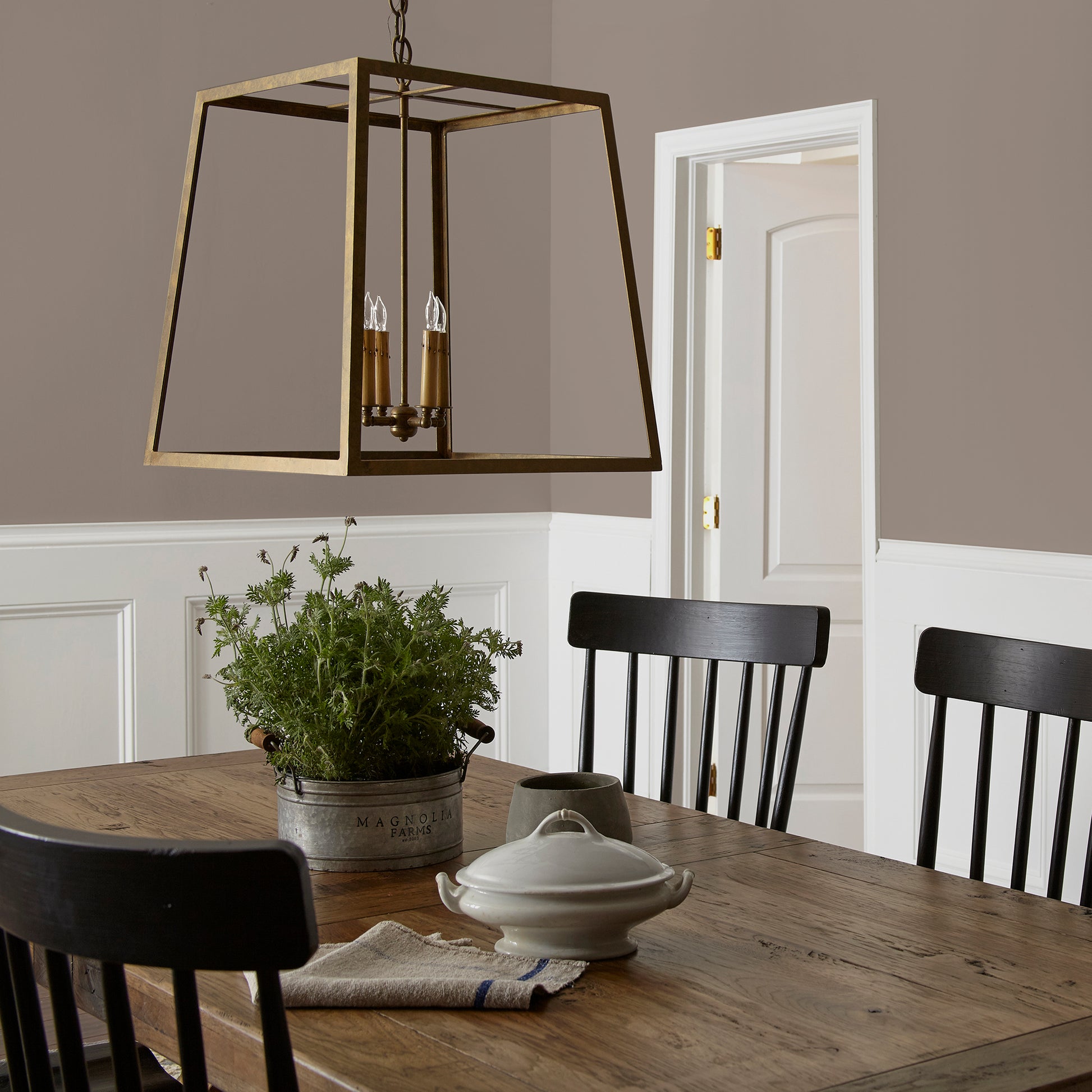 A warm brown with yellow accents interior paint named elemental shown painted on dining room wall