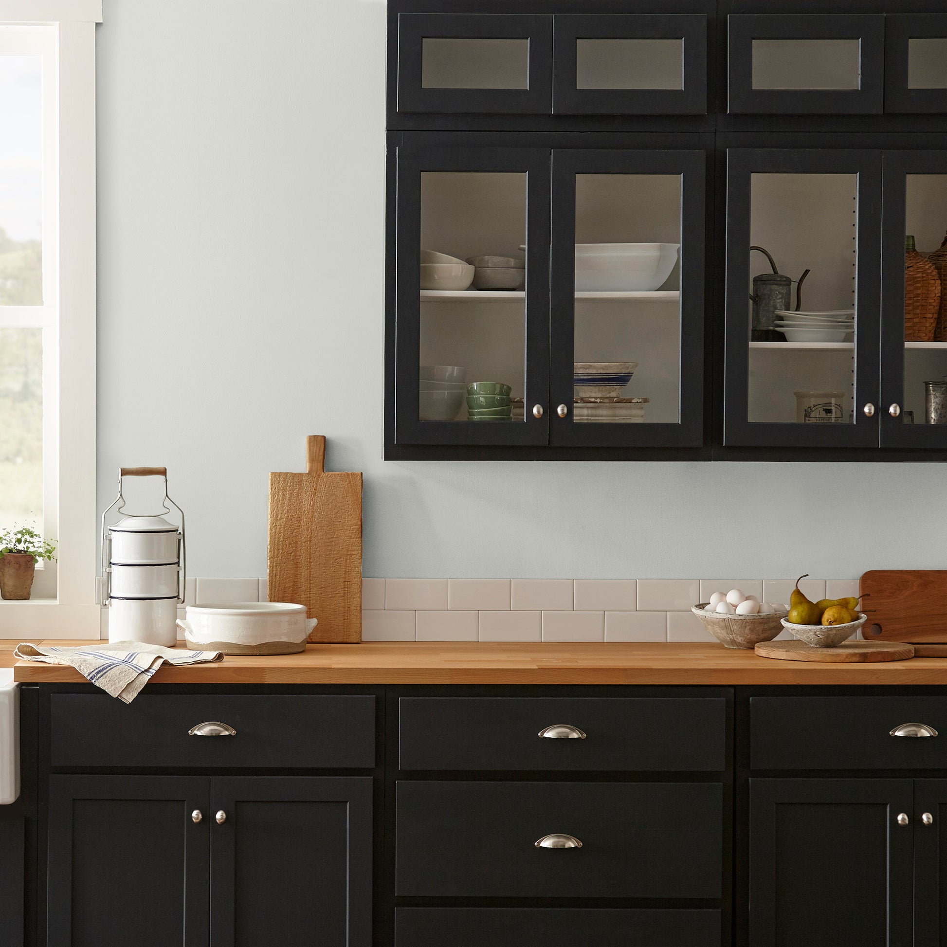 Almost white with gray and green undertones interior paint named chime gray shown painted on kitchen wall