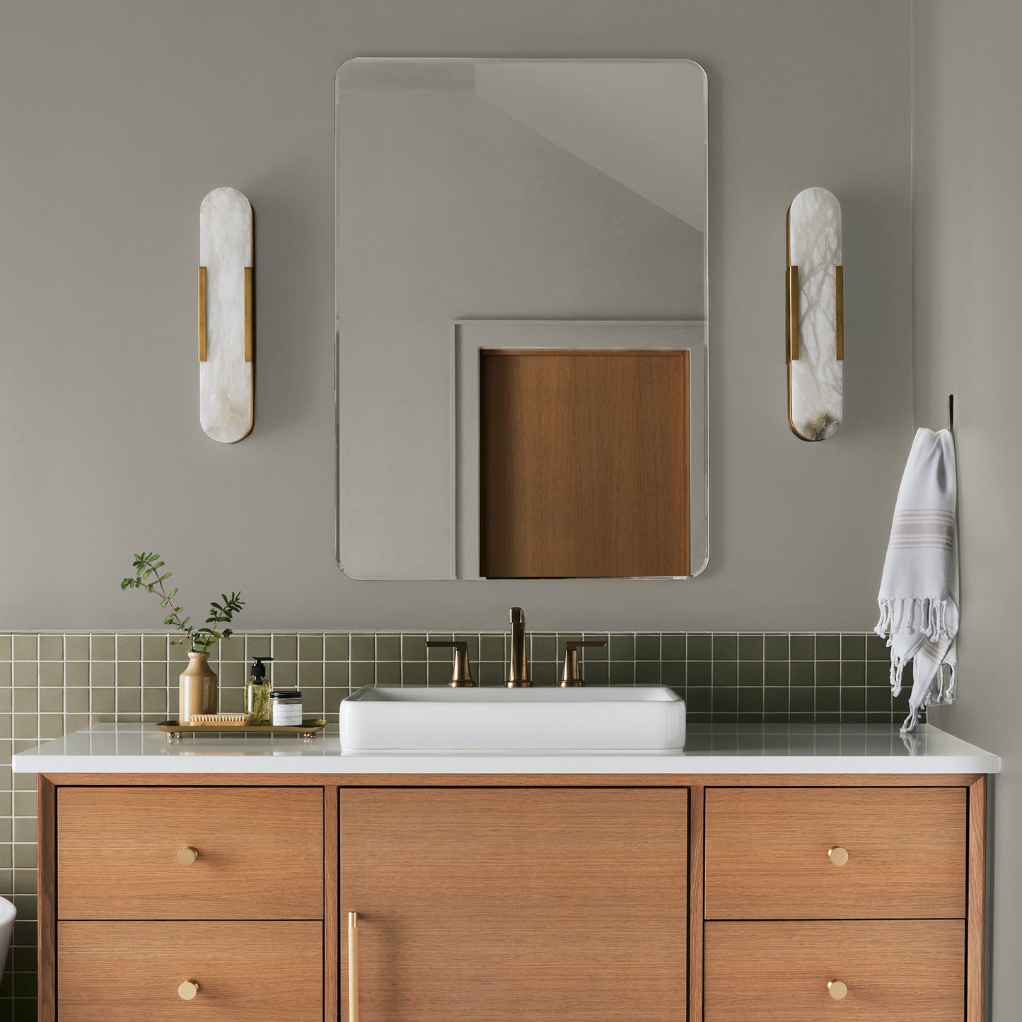 Warm chalky pale green interior paint named flower jar shown painted on bathroom wall