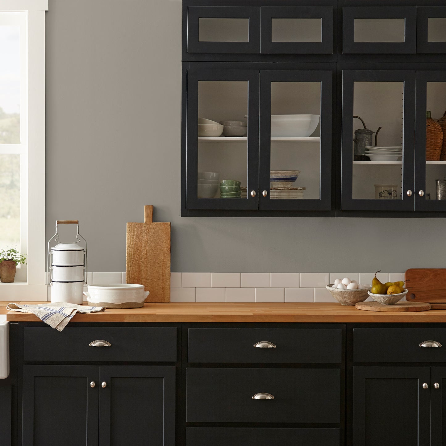 Muted smoky brown interior paint named reclaimed wood shown painted on kitchen wall