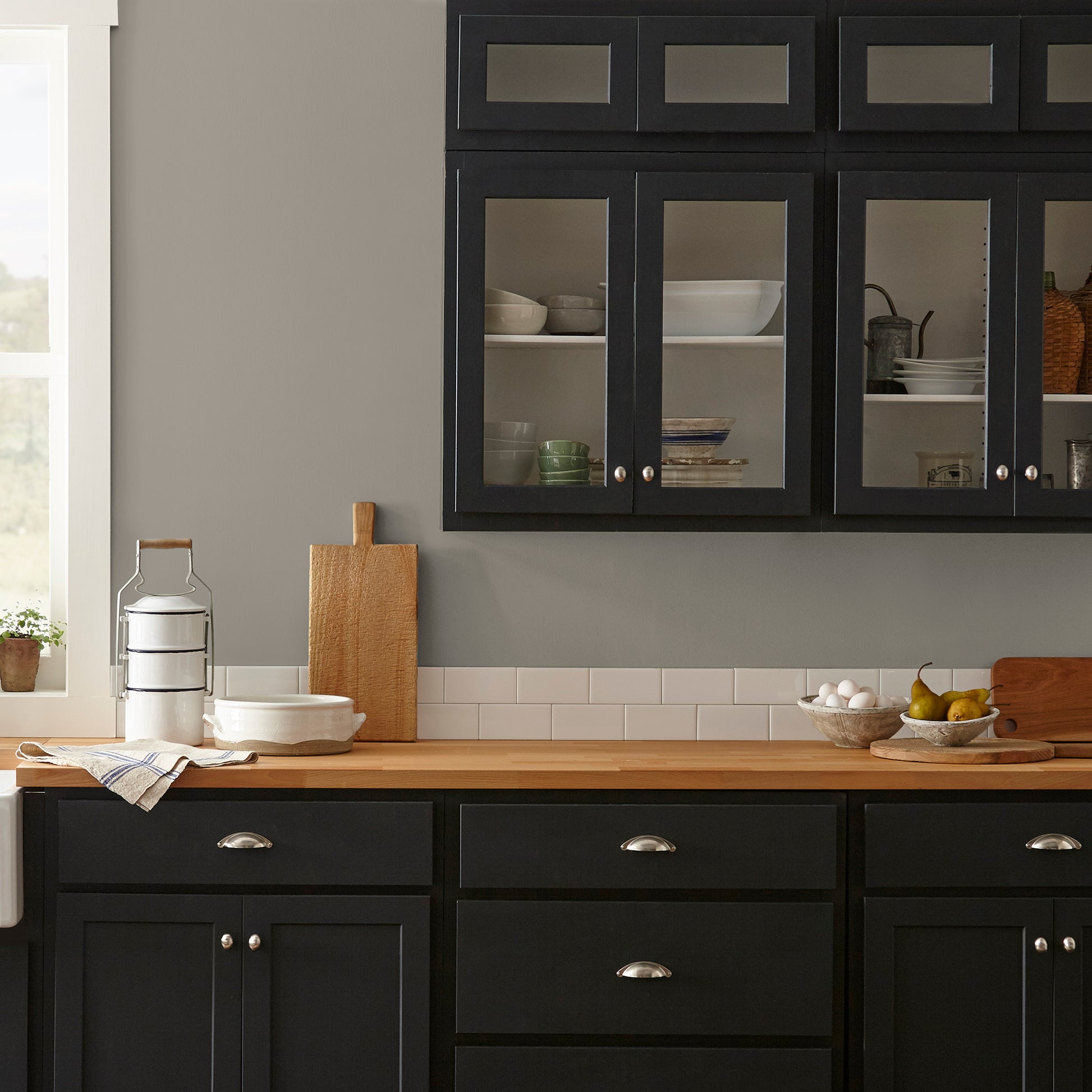Muted smoky brown interior paint named reclaimed wood shown painted on kitchen wall