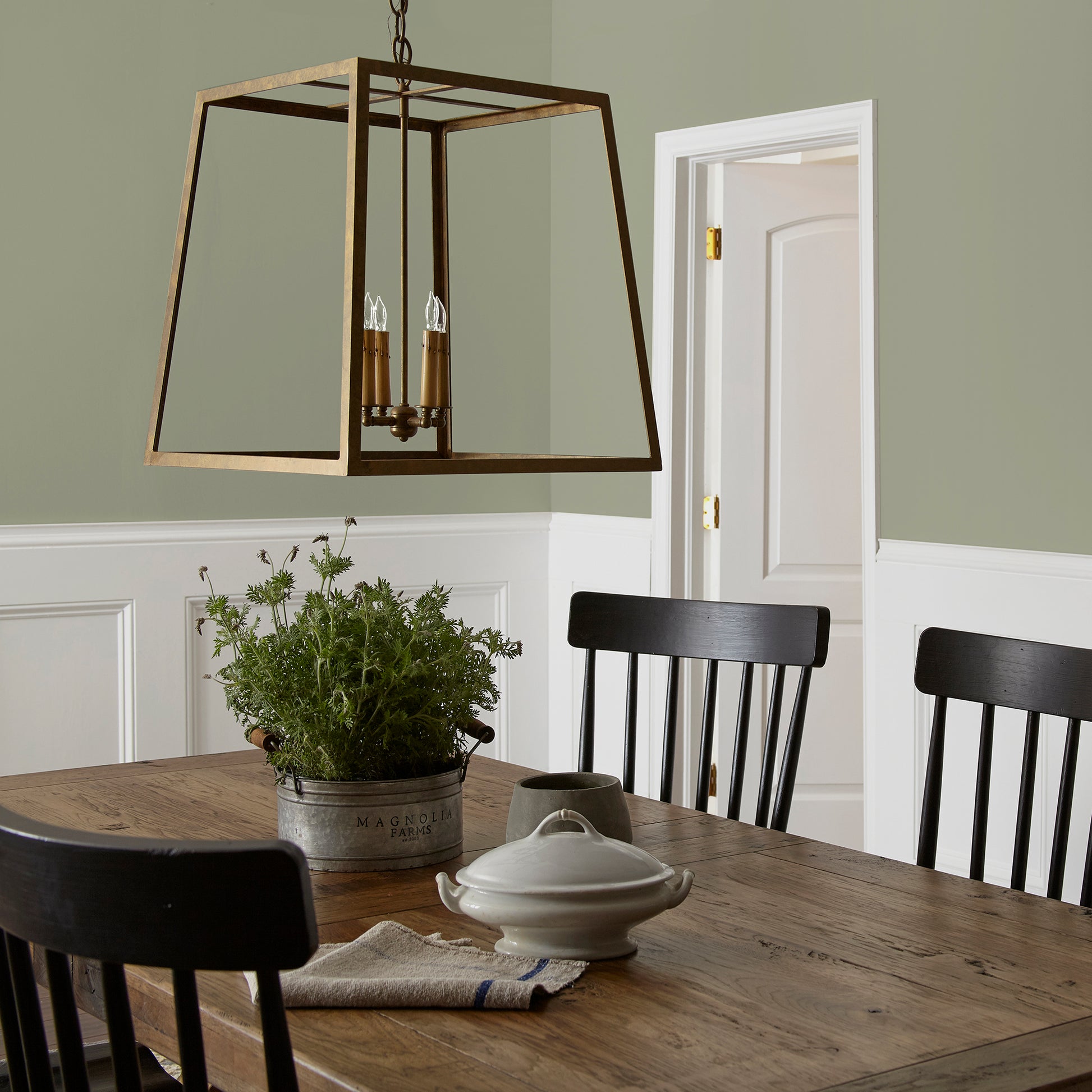 dark grey-green interior paint named garden essential shown painted on dining room wall