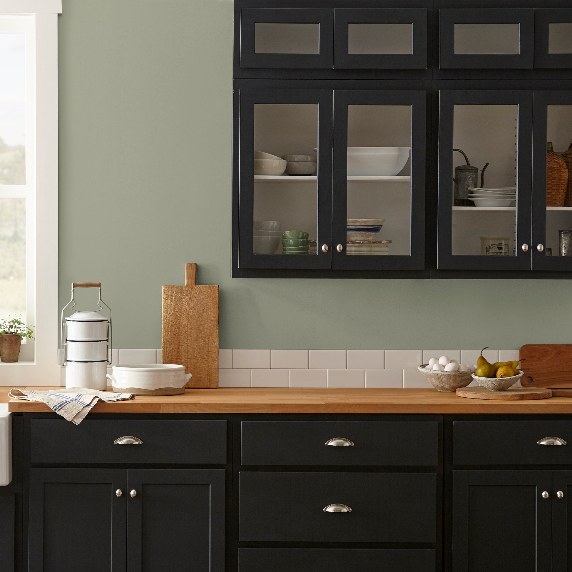dark grey-green interior paint named garden essential shown painted on kitchen wall