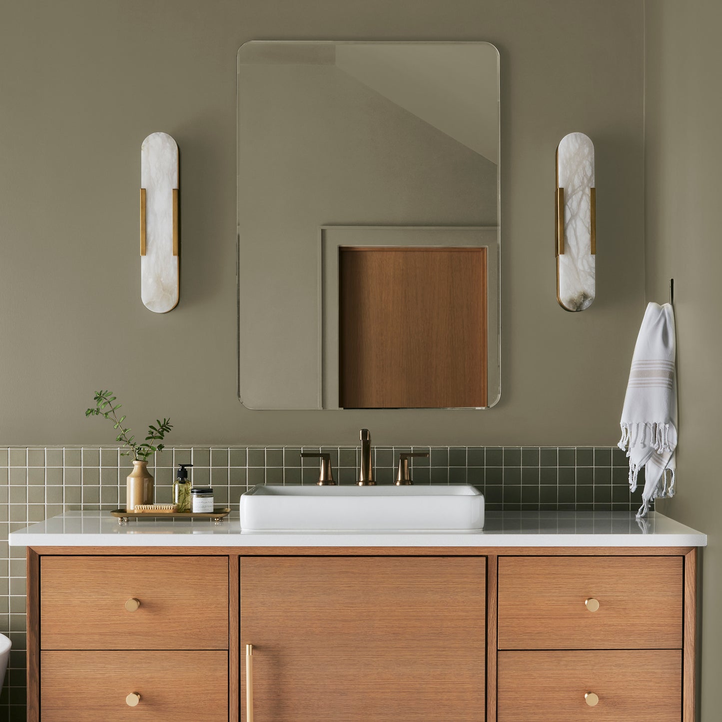 Ashy olive green interior paint named countryside shown painted on bathroom wall