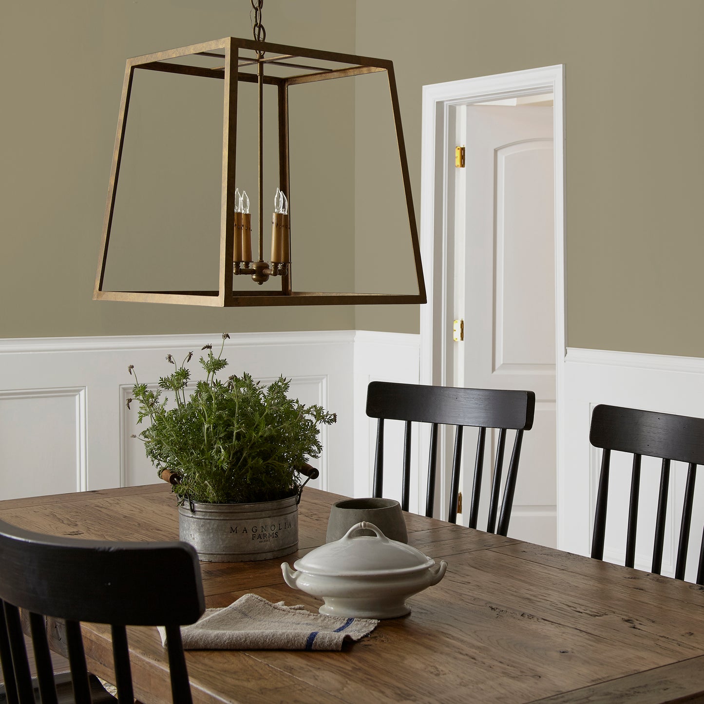 Ashy olive green interior paint named countryside shown painted on dining room wall