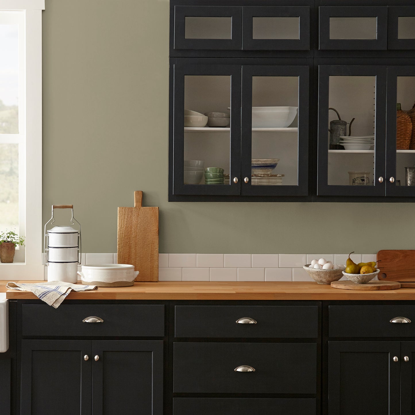 Ashy olive green interior paint named countryside shown painted on kitchen wall
