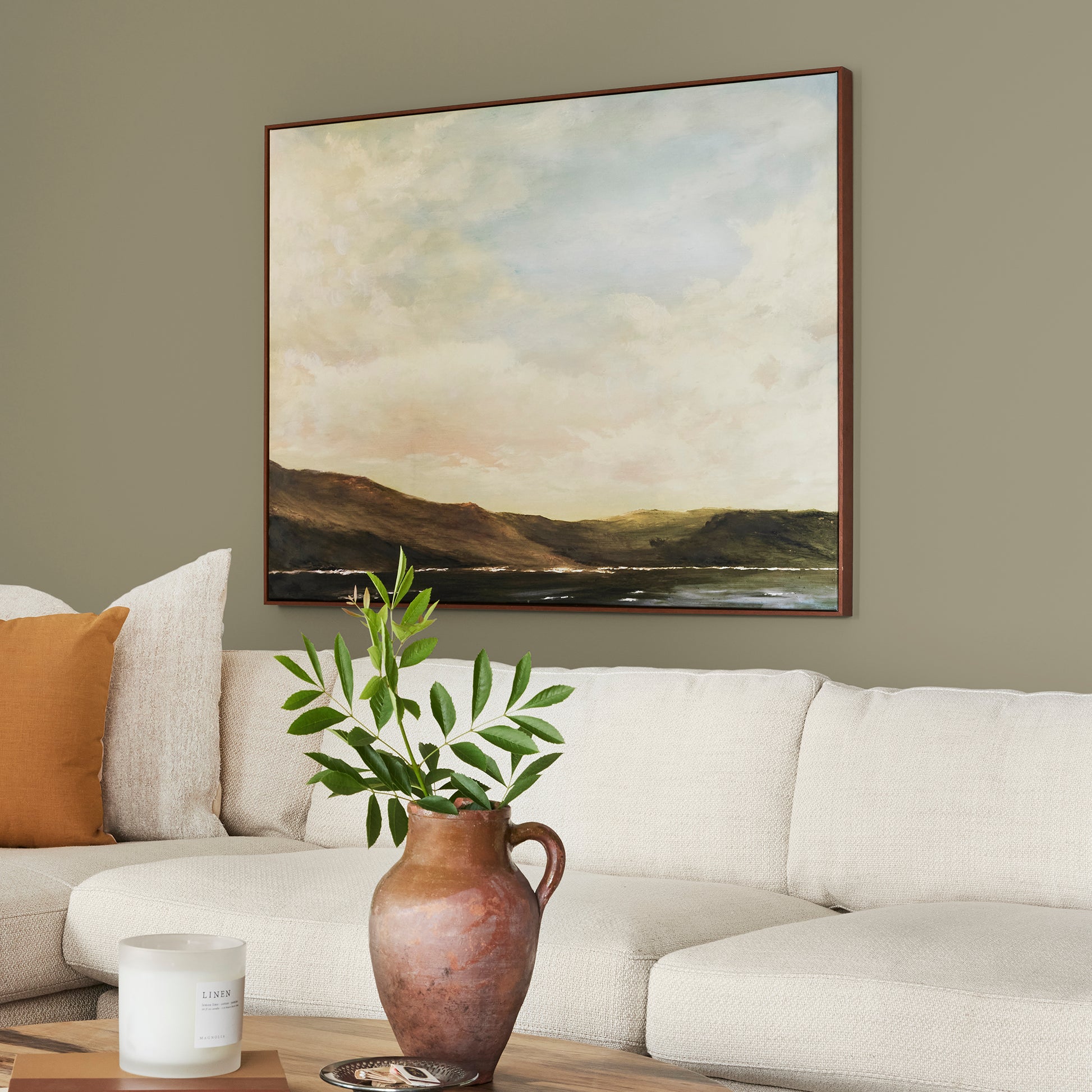 Ashy olive green interior paint named countryside shown painted on living room wall