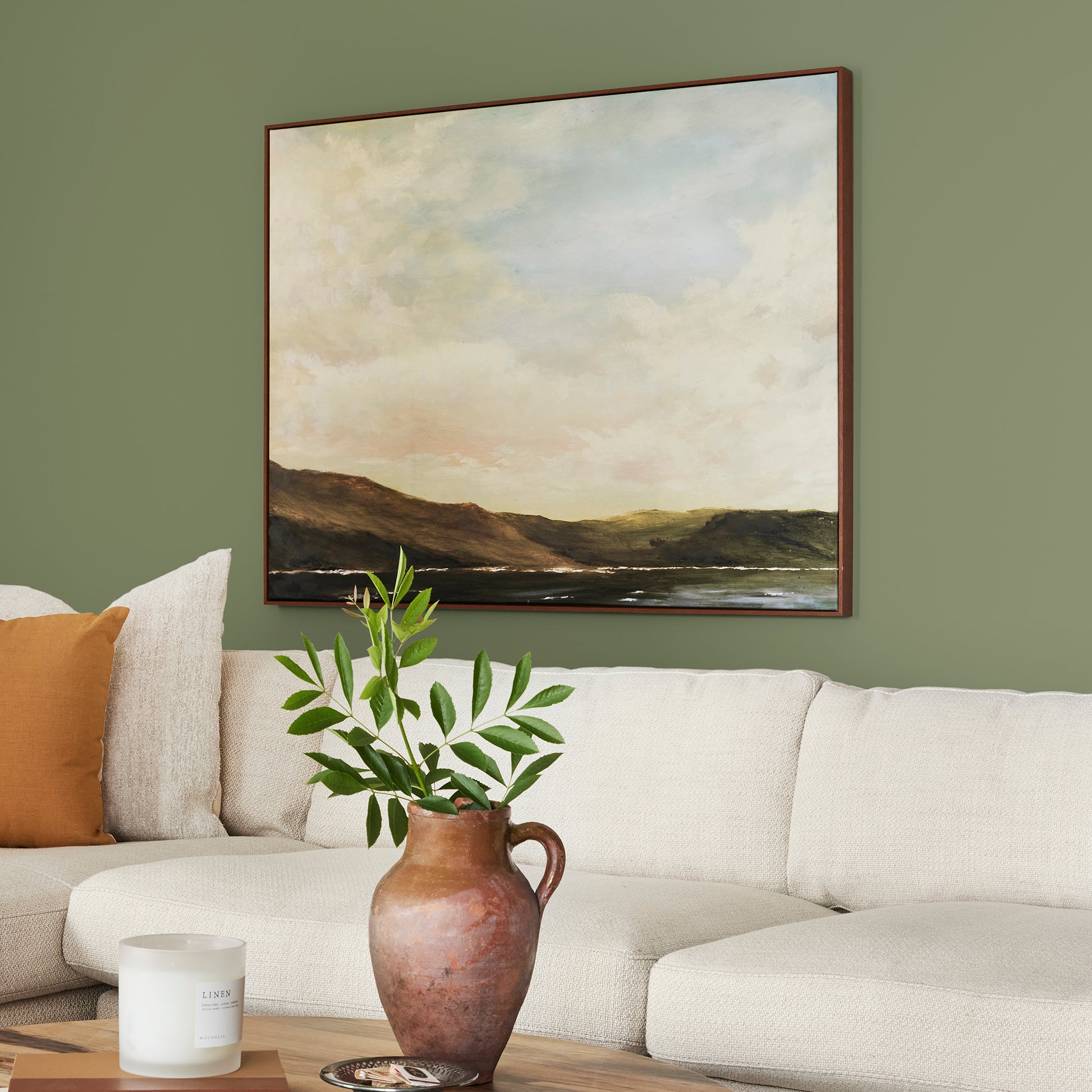 medium avocado green interior paint named celery seed shown painted on living room wall