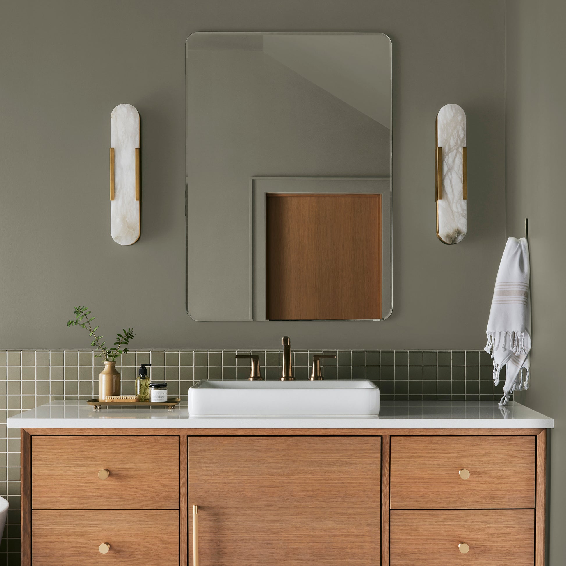 Lighter shade of army green with notes of hazel interior paint named garden party shown painted on bathroom wall