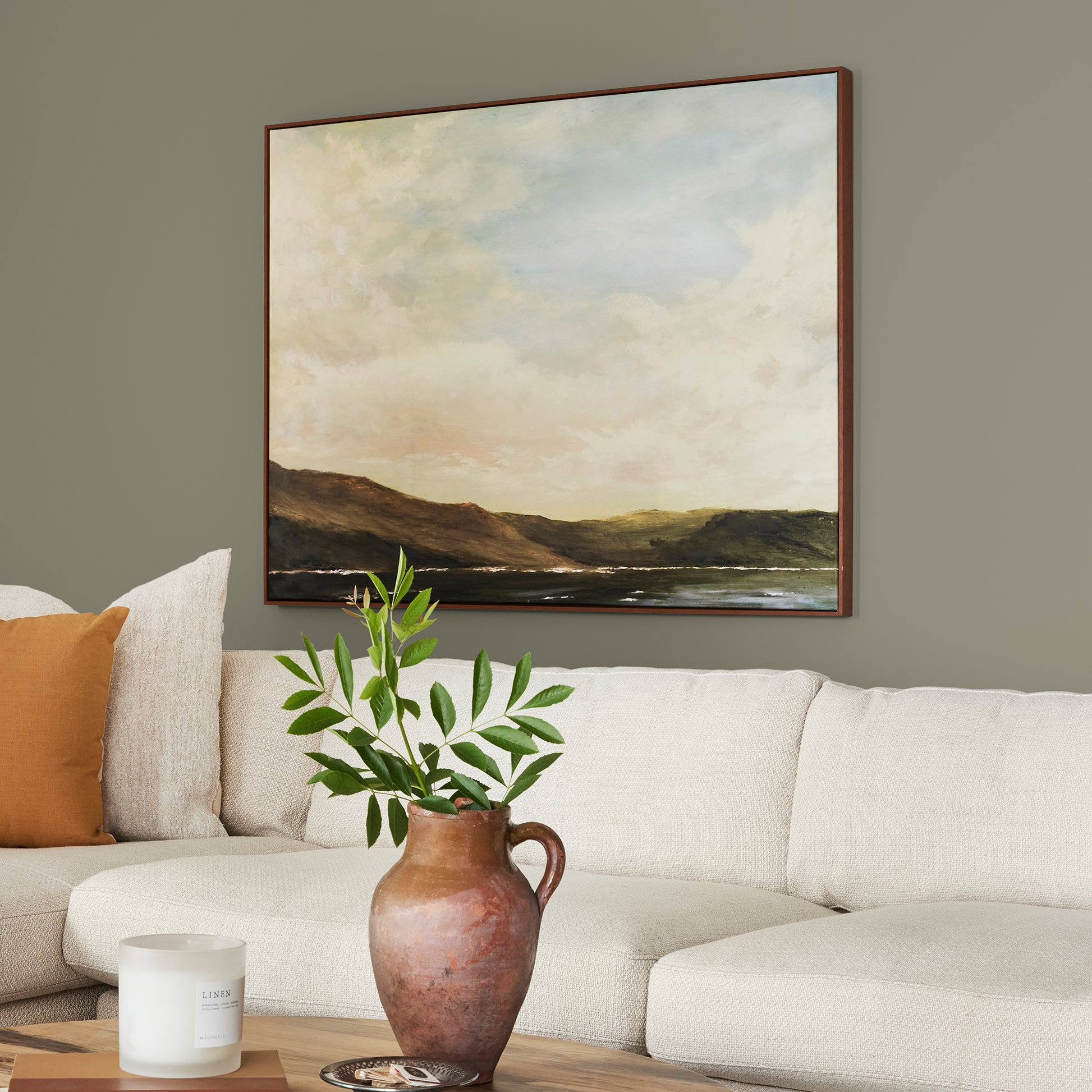 Lighter shade of army green with notes of hazel interior paint named garden party shown painted on living room wall