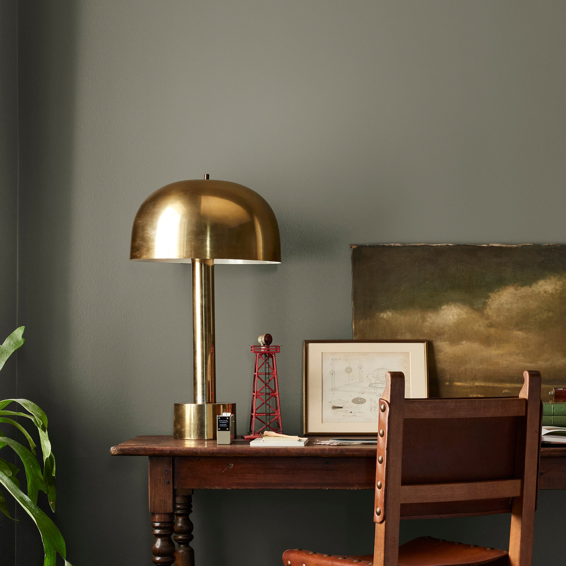A warm olive green interior paint named market place shown painted on bedroom wall