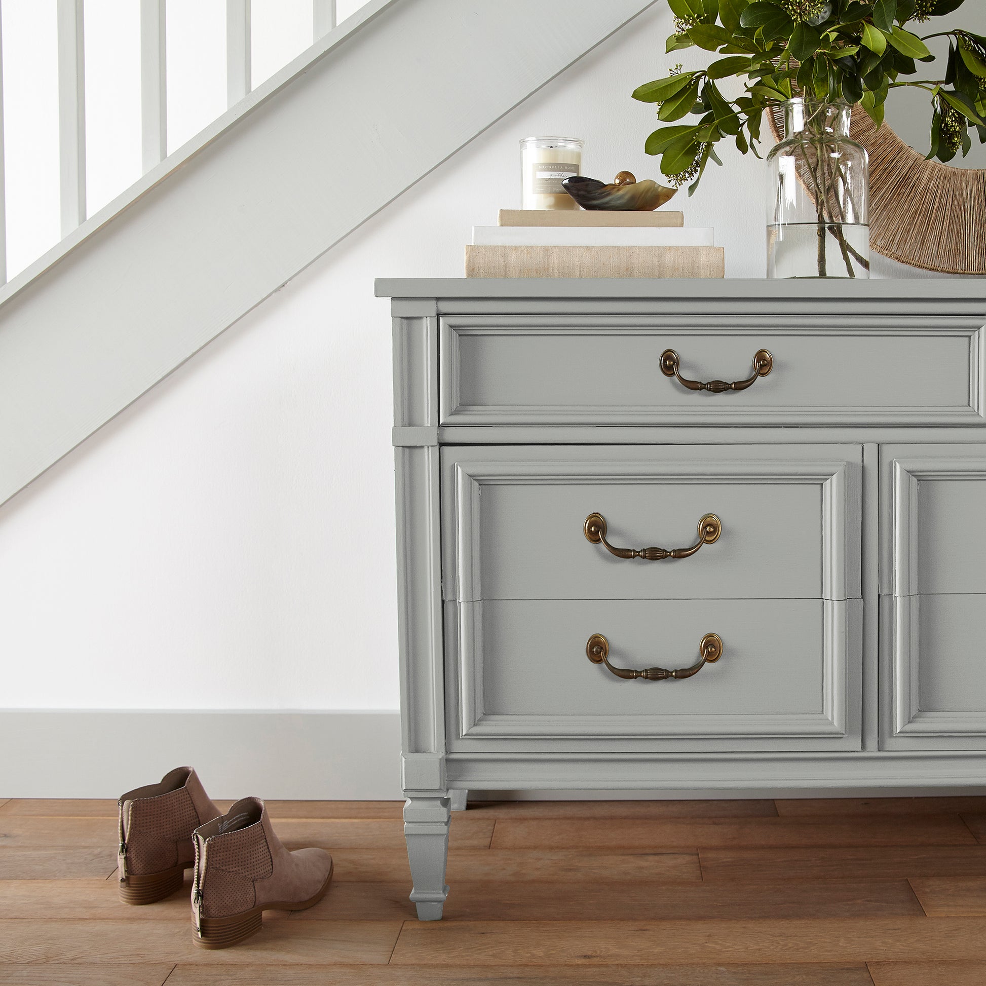 Light mid-tone gray door and cabinet paint named day-to-day shown painted on entryway cabinet