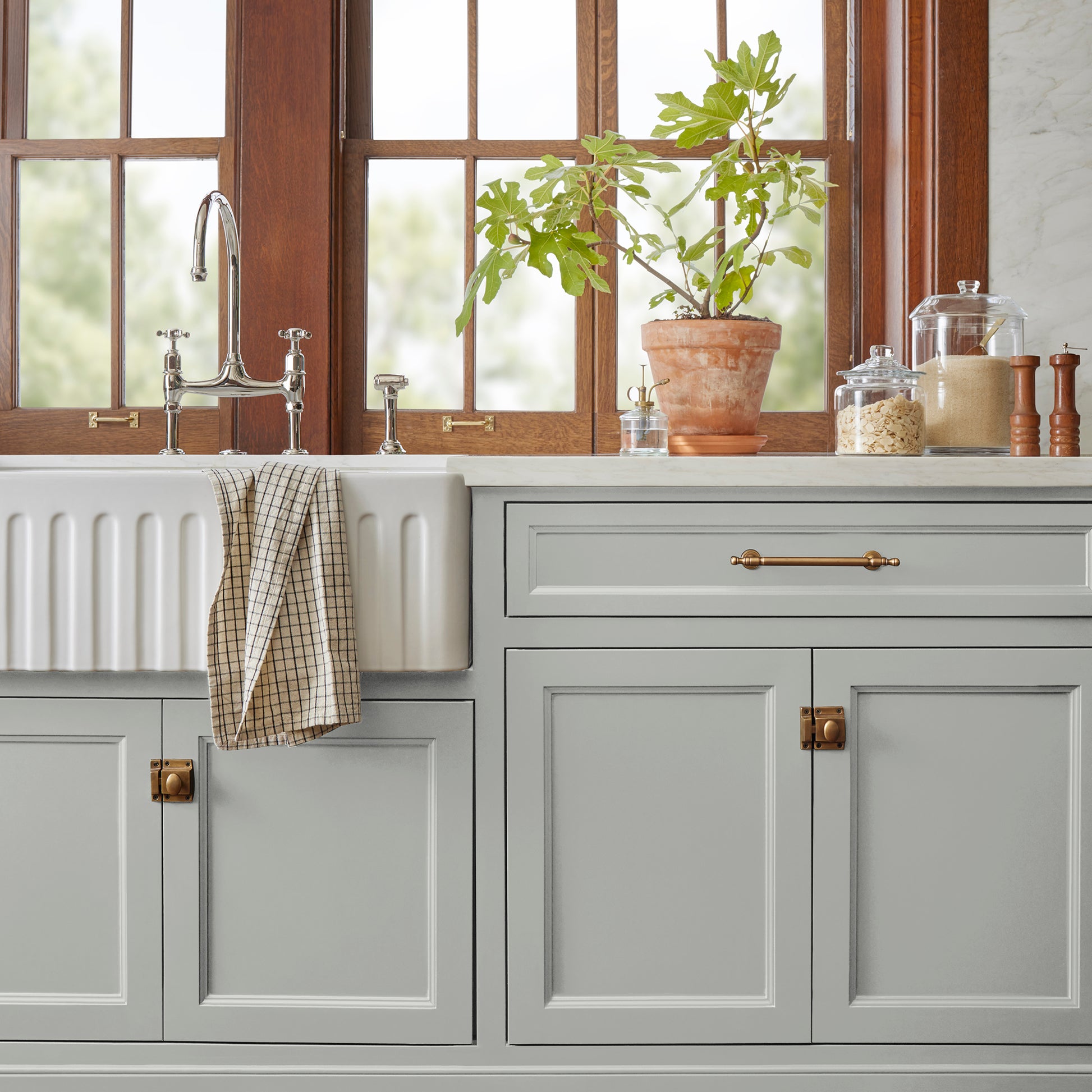 Light mid-tone gray door and cabinet paint named day-to-day shown painted on kitchen cabinet