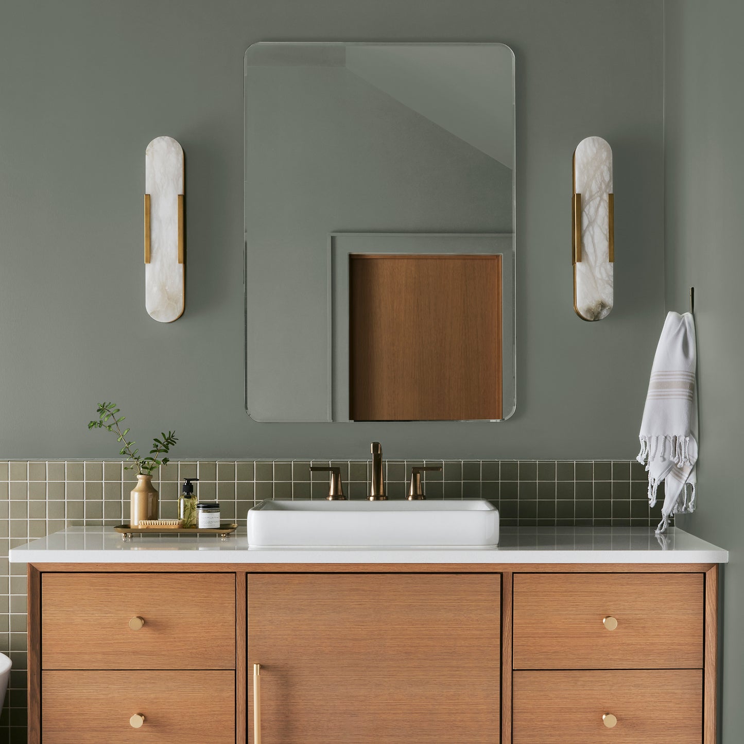 Pale ivy green interior paint named eden shown painted on bathroom wall