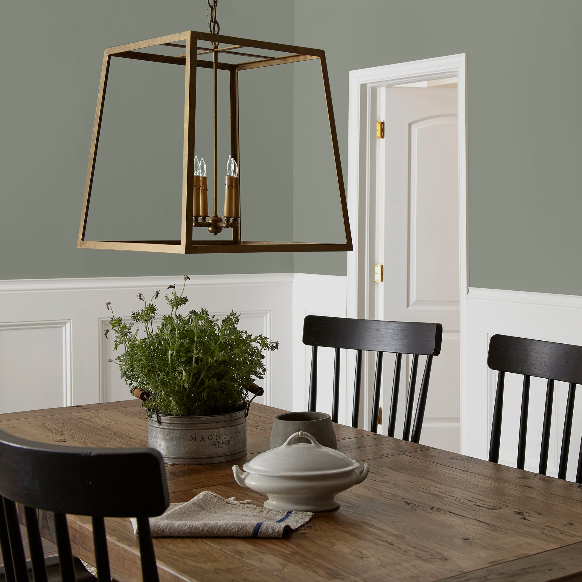 Pale ivy green interior paint named eden shown painted on dining room wall