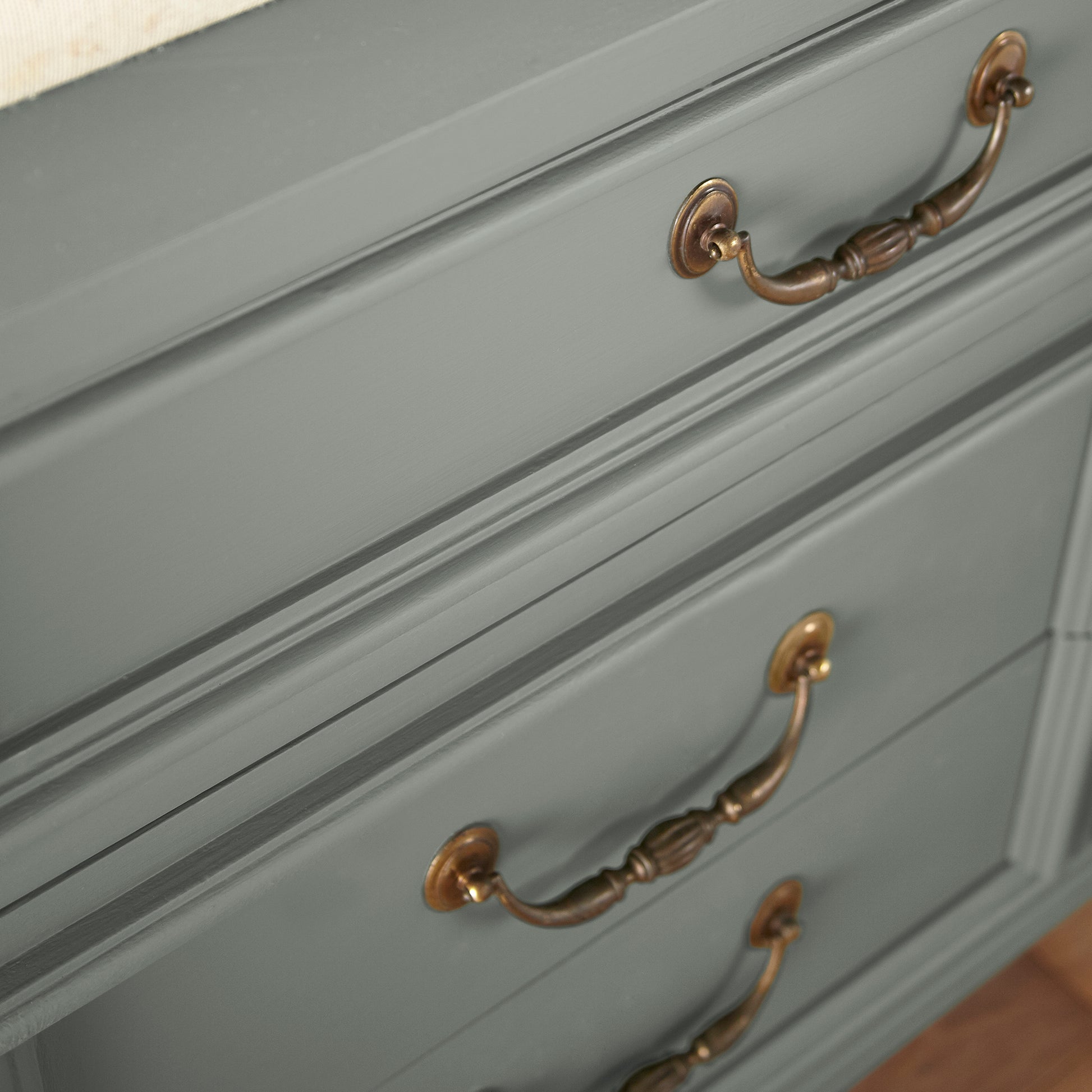 Mid-tone sage green blended with earthy gray door and cabinet paint named sage stem shown painted on cabinet