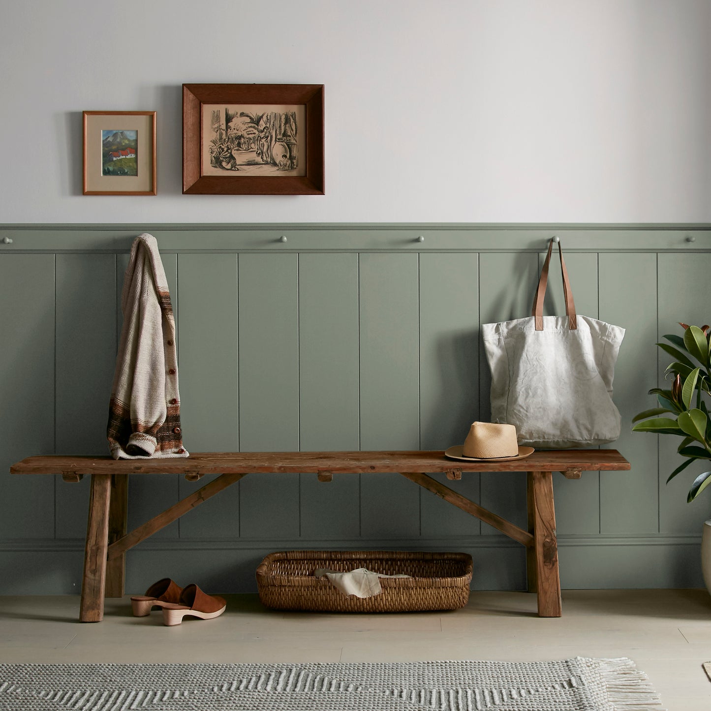 A dusty olive green interior paint named bespoke green shown painted on entryway wall