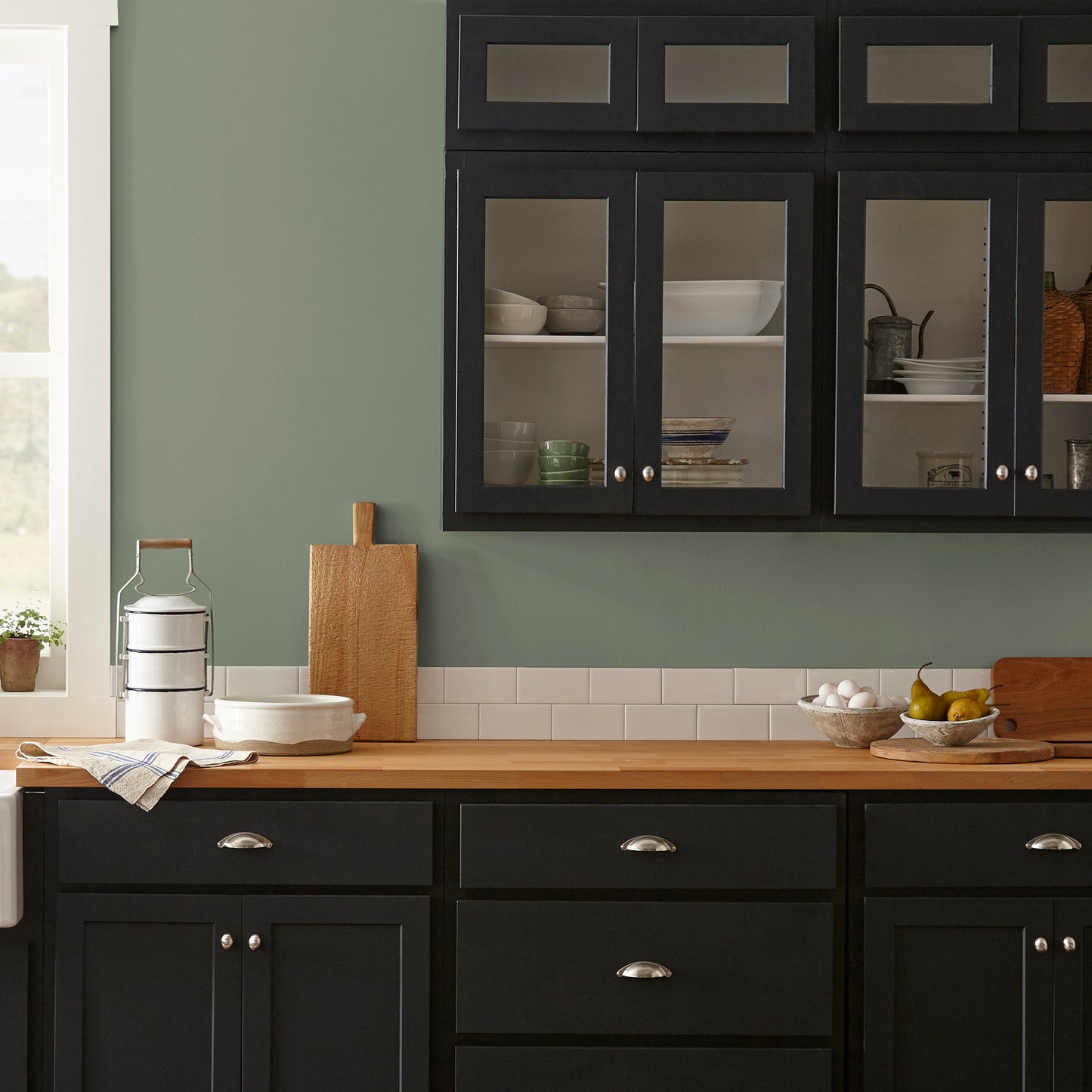 A dusty olive green interior paint named bespoke green shown painted on kitchen wall