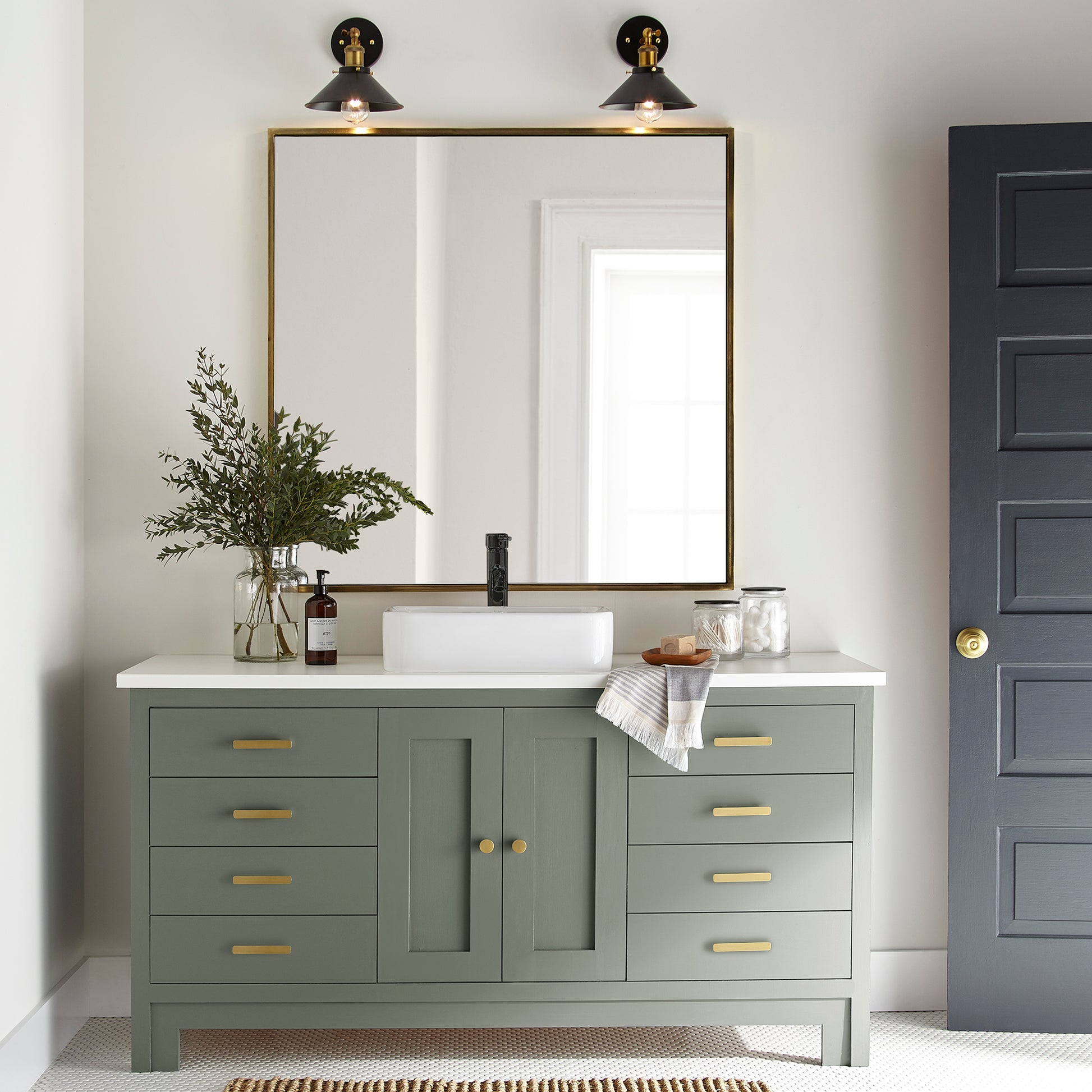 A dusty olive green door and cabinet paint named bespoke green shown painted on bathroom cabinet
