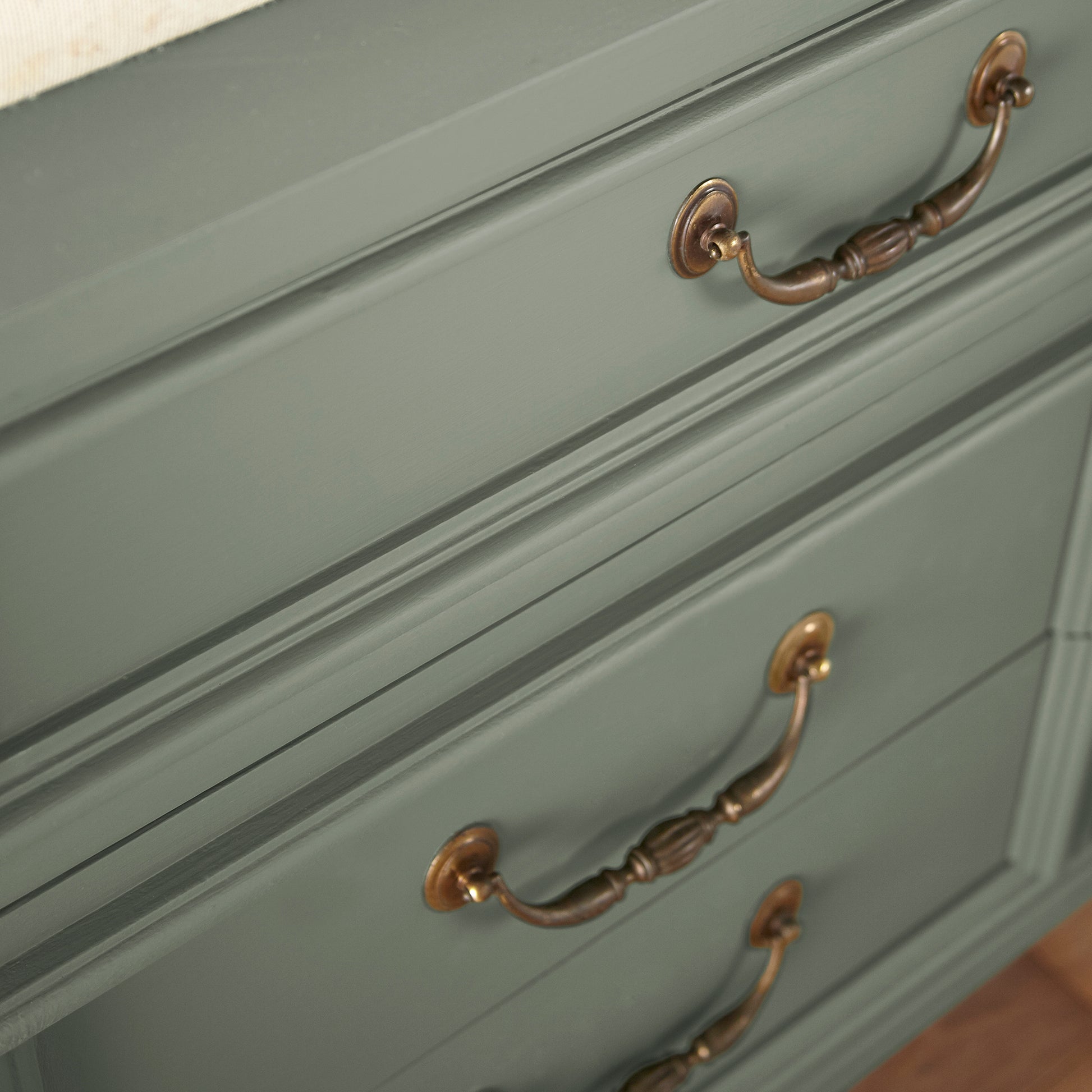 Soft light gray with blue undertone door and cabinet paint named bespoke green shown painted on cabinet