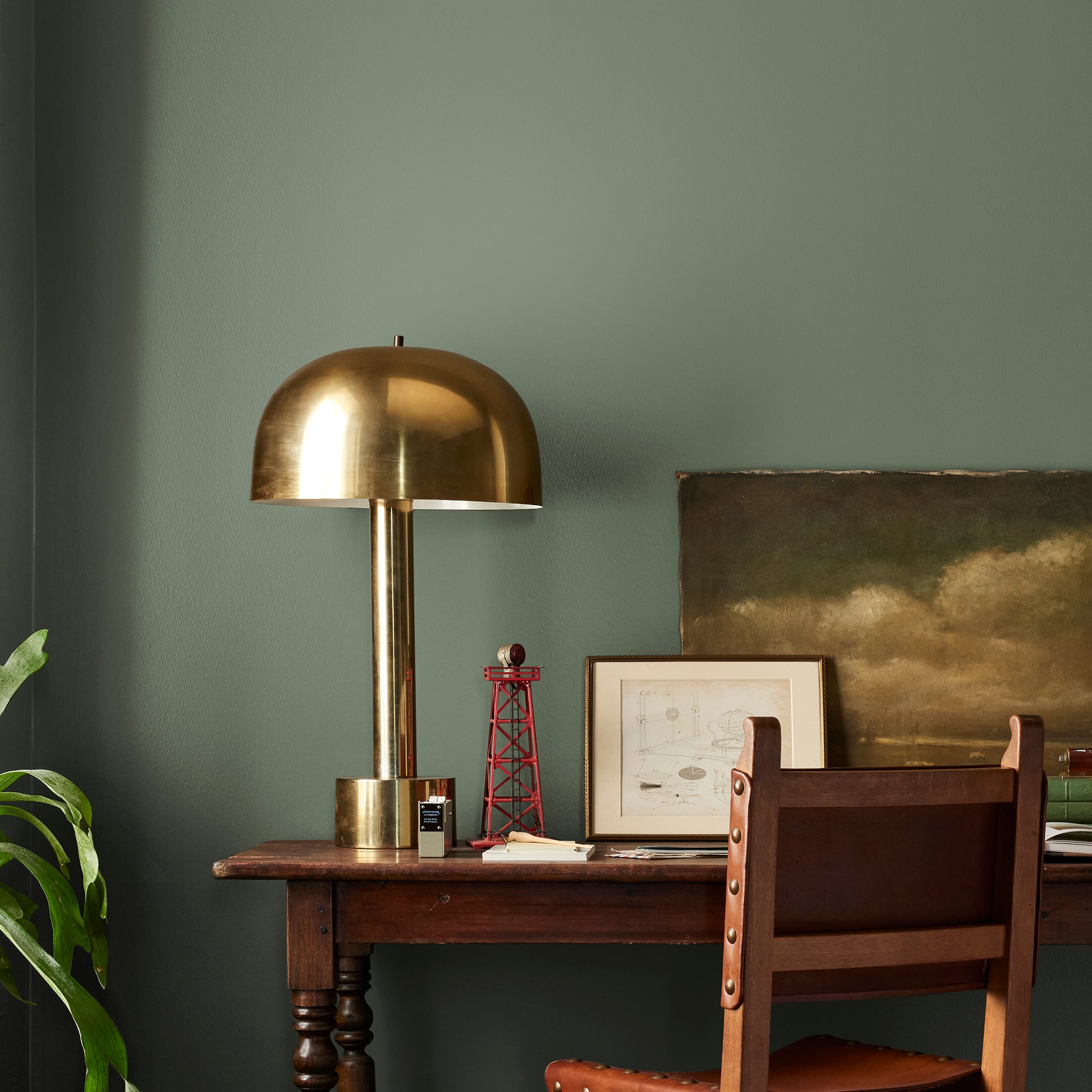 dark sage green paint named lemon leaves shown painted on bedroom wall